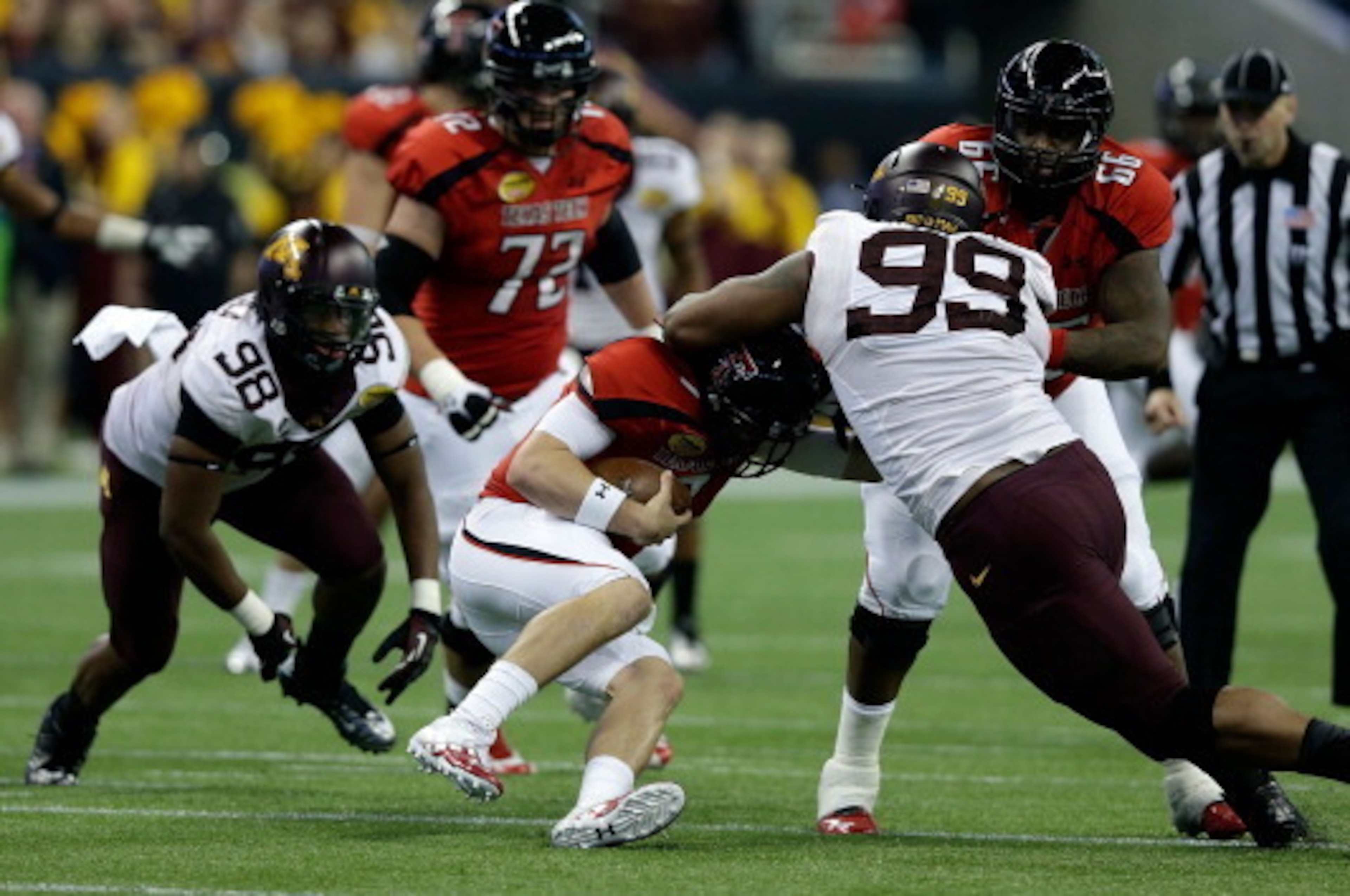 HOUSTON, TX - DECEMBER 28:  Seth Doege #7 of Texas Tech is sacked by Ra'Shede Hageman #99 of Minnesota during the Meineke Car Care of Texas Bowl at Reliant Stadium on December 28, 2012 in Houston, Texas.  (Photo by Scott Halleran/Getty Images)