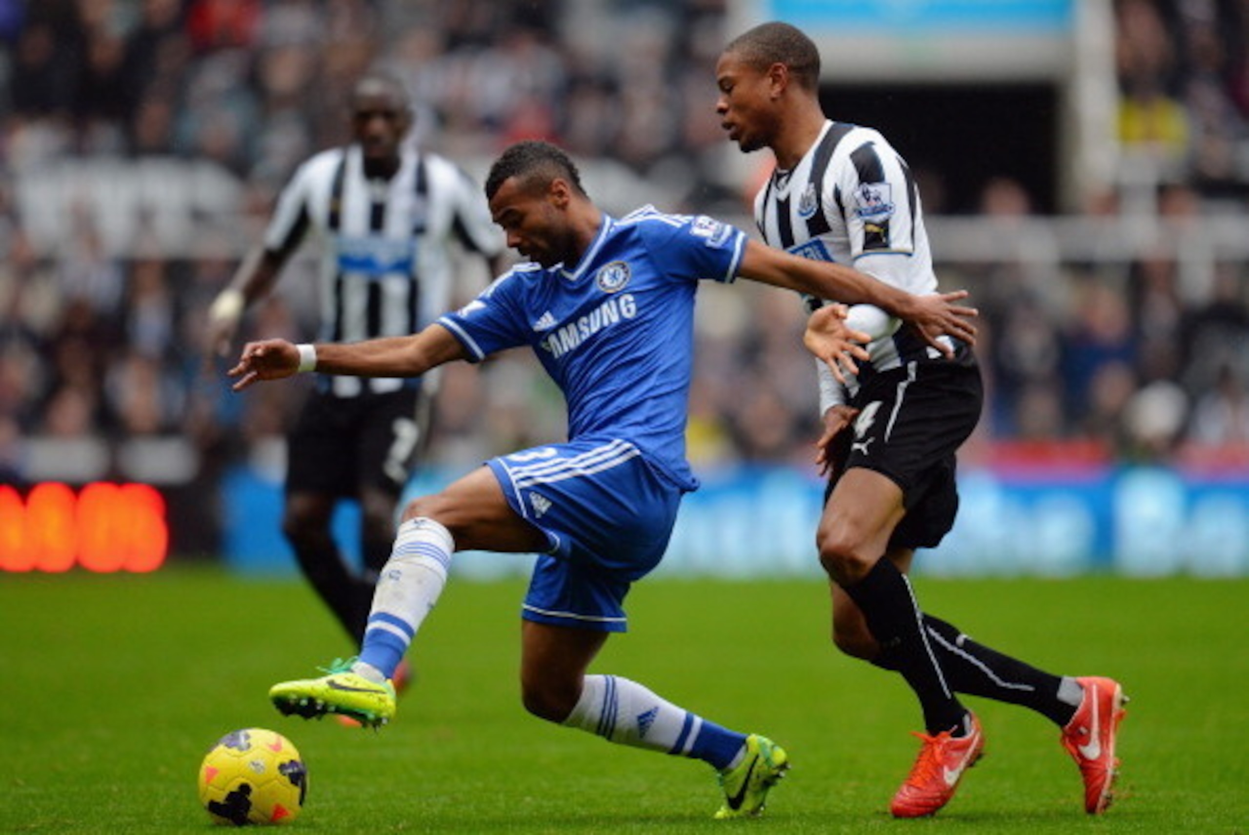 NEWCASTLE UPON TYNE, ENGLAND - NOVEMBER 02:  Loic Remy of Newcastle United and Ashley Cole of Chelsea compete  for the ball during the Barclays Premier League match between Newcastle United and Chelsea at St James' Park on November 2, 2013 in Newcastle up