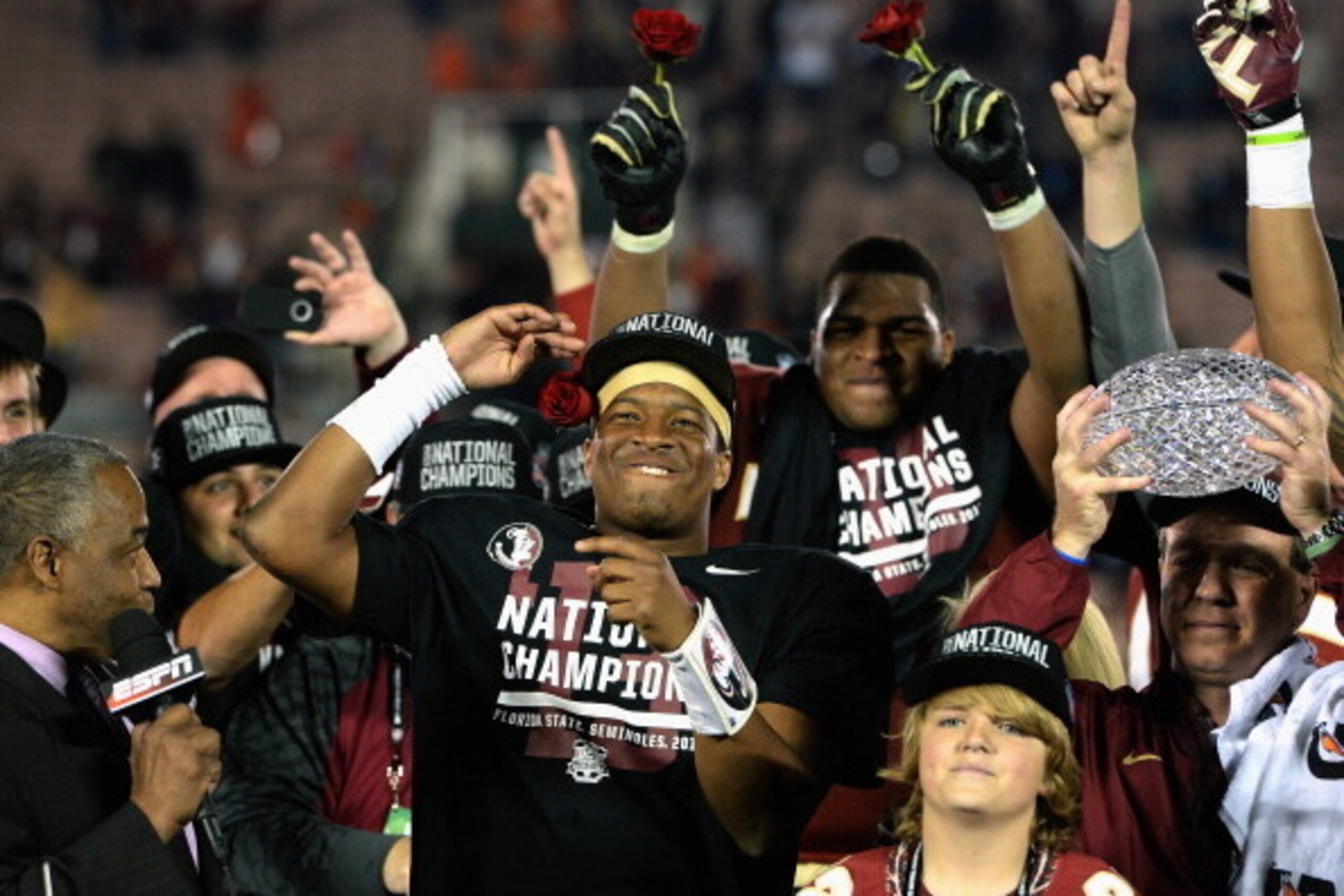 PASADENA, CA - JANUARY 06:  Florida State Seminoles head coach Jimbo Fisher (R) holds the Coaches' Trophy as quarterback Jameis Winston (center) #5 celebrates after defeating the Auburn Tigers 34-31 in the 2014 Vizio BCS National Championship Game at the 