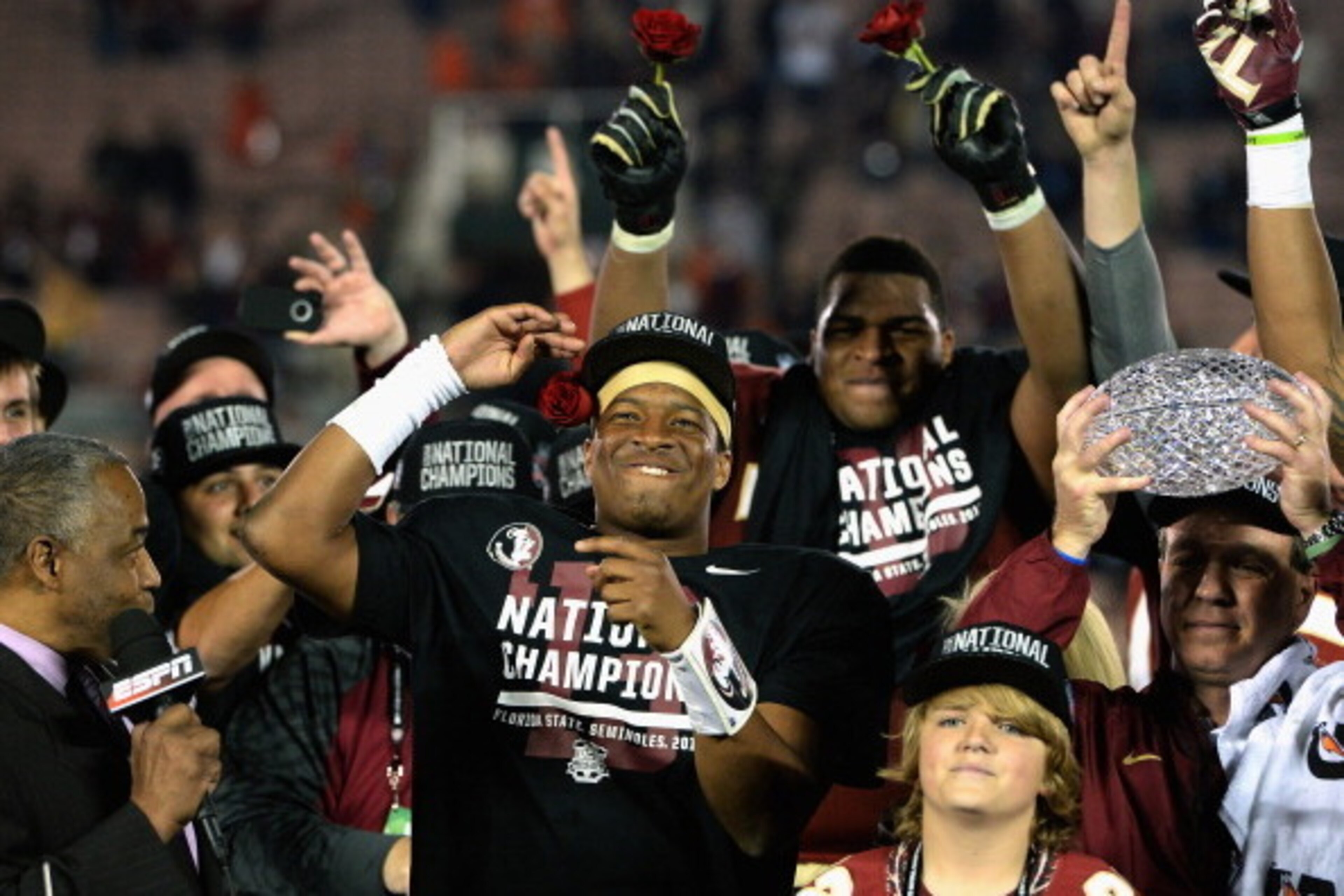 PASADENA, CA - JANUARY 06:  Florida State Seminoles head coach Jimbo Fisher (R) holds the Coaches' Trophy as quarterback Jameis Winston (center) #5 celebrates after defeating the Auburn Tigers 34-31 in the 2014 Vizio BCS National Championship Game at the 
