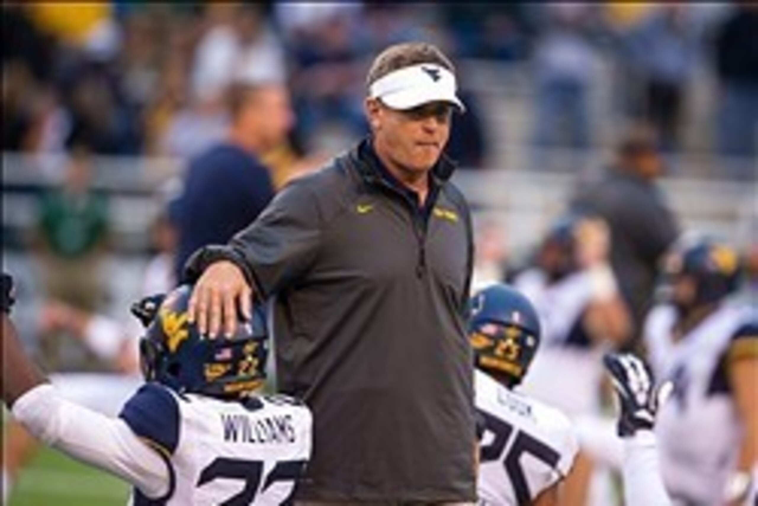 Oct 5, 2013; Waco, TX, USA; West Virginia Mountaineers defensive coordinator Keith Patterson watches his team warm up before the game against the Baylor Bears at Floyd Casey Stadium. The Bears defeated the Mountaineers 73-42. Mandatory Credit: Jerome Miro