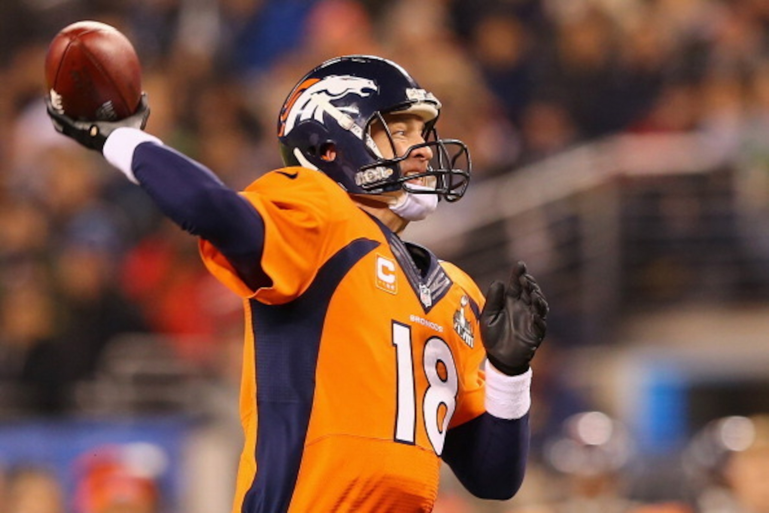 EAST RUTHERFORD, NJ - FEBRUARY 02:  Quarterback Peyton Manning #18 of the Denver Broncos throws a pass during Super Bowl XLVIII at MetLife Stadium on February 2, 2014 in East Rutherford, New Jersey.  (Photo by Elsa/Getty Images)
