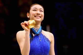 VANCOUVER, BC - FEBRUARY 25:  Kim Yu-Na of South Korea celebrates winning the gold medal in the Ladies Free Skating during the medal ceremony on day 14 of the 2010 Vancouver Winter Olympics at Pacific Coliseum on February 25, 2010 in Vancouver, Canada.  (