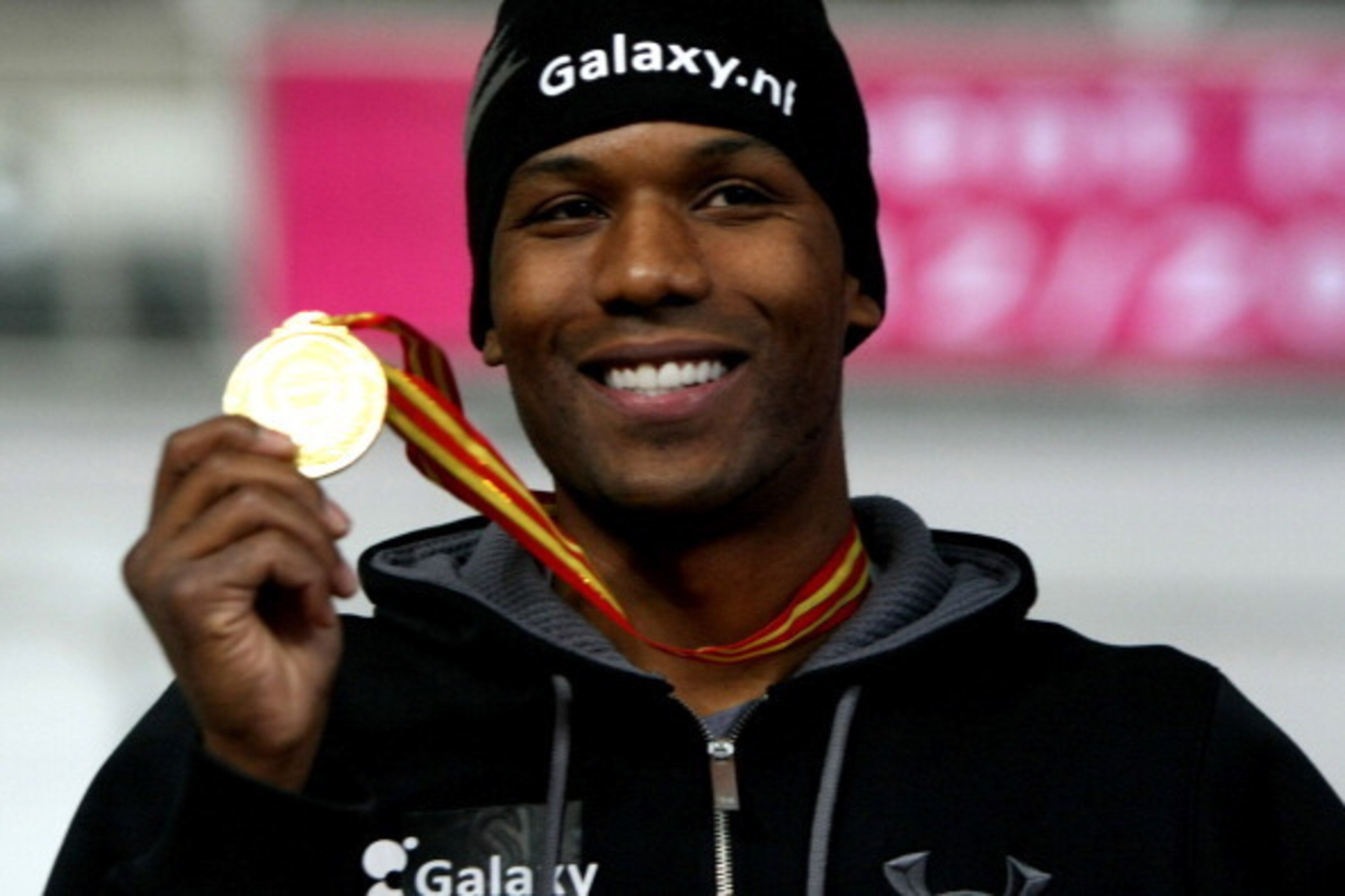 HARBIN, CHINA - DECEMBER 15:  Shani Davis of USA holds the gold medal to celebrate during the award ceremony after winning the Division A Men's 1000m race during the day one of the Essent ISU World Cup Speed Skating at Harbin Ice Training Base on December