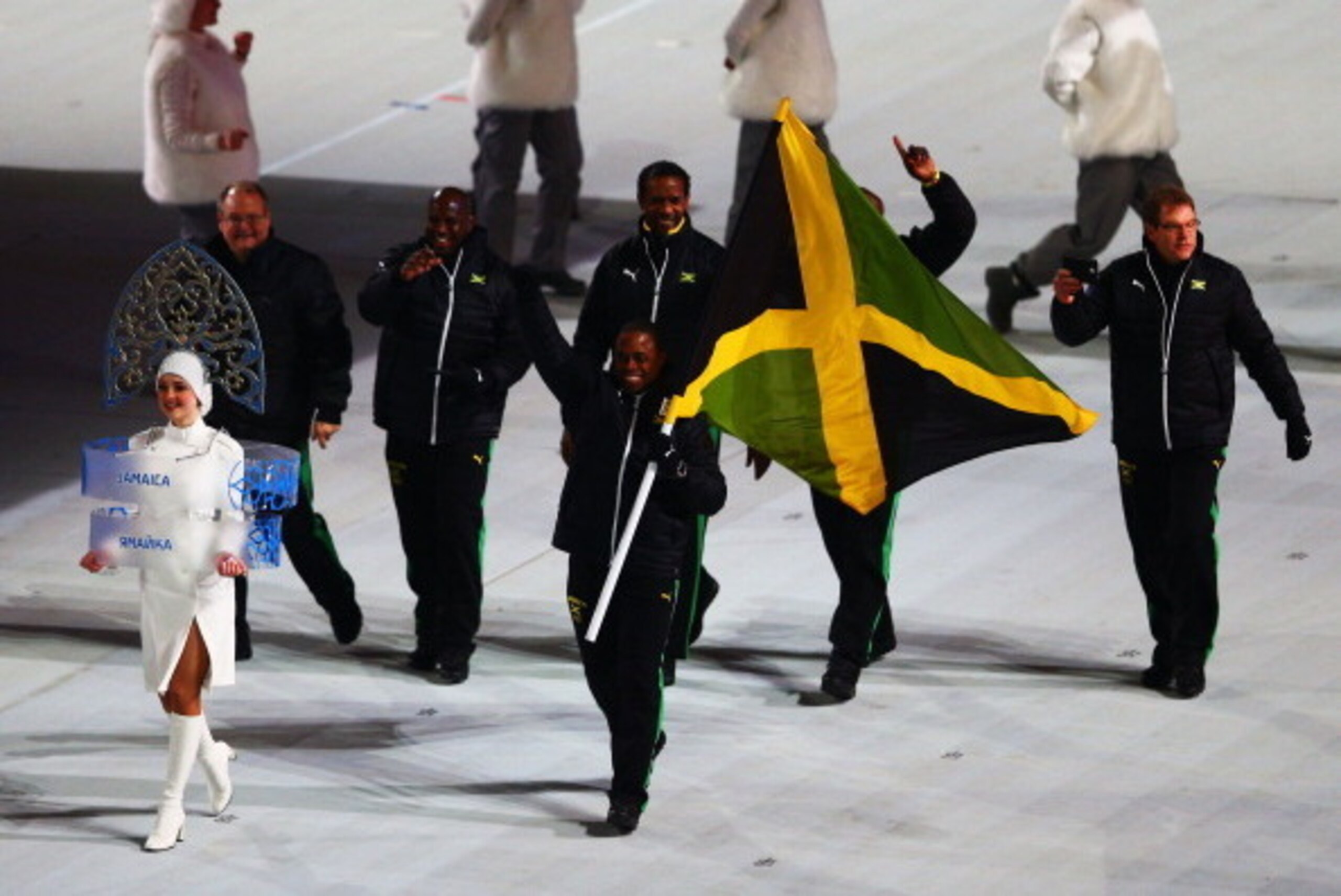 SOCHI, RUSSIA - FEBRUARY 07: Bobsleigh racer Marvin Dixon of the Jamaica Olympic team carries his country's flag during the Opening Ceremony of the Sochi 2014 Winter Olympics at Fisht Olympic Stadium on February 7, 2014 in Sochi, Russia. (Photo by Clive SOCHI, RUSSIA - FEBRUARY 07: Bobsleigh racer Marvin Dixon of the Jamaica Olympic team carries his country's flag during the Opening Ceremony of the Sochi 2014 Winter Olympics at Fisht Olympic Stadium on February 7, 2014 in Sochi, Russia. (Photo by Clive