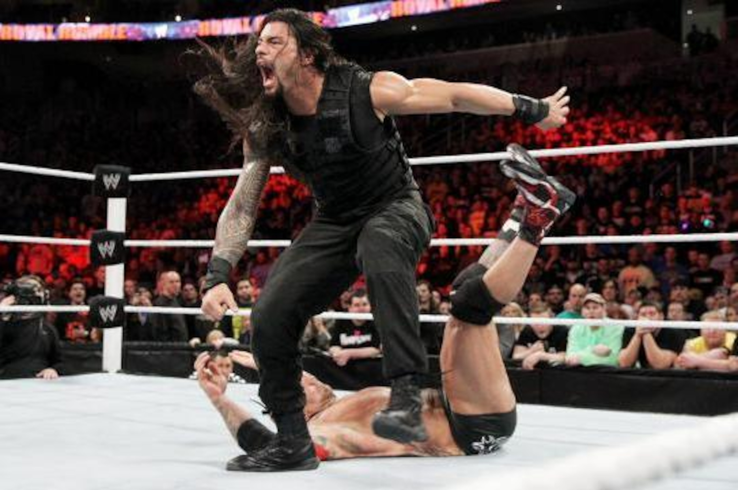 Roman Reigns knocks Batista over at the Royal Rumble.