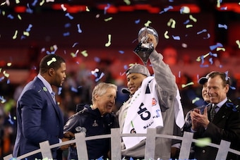 EAST RUTHERFORD, NJ - FEBRUARY 02:  MVP Malcolm Smith #53 of the Seattle Seahawks celebrates with the Vince Lombardi Trophy after their 43-8 victory over the Denver Broncos during Super Bowl XLVIII at MetLife Stadium on February 2, 2014 in East Rutherford