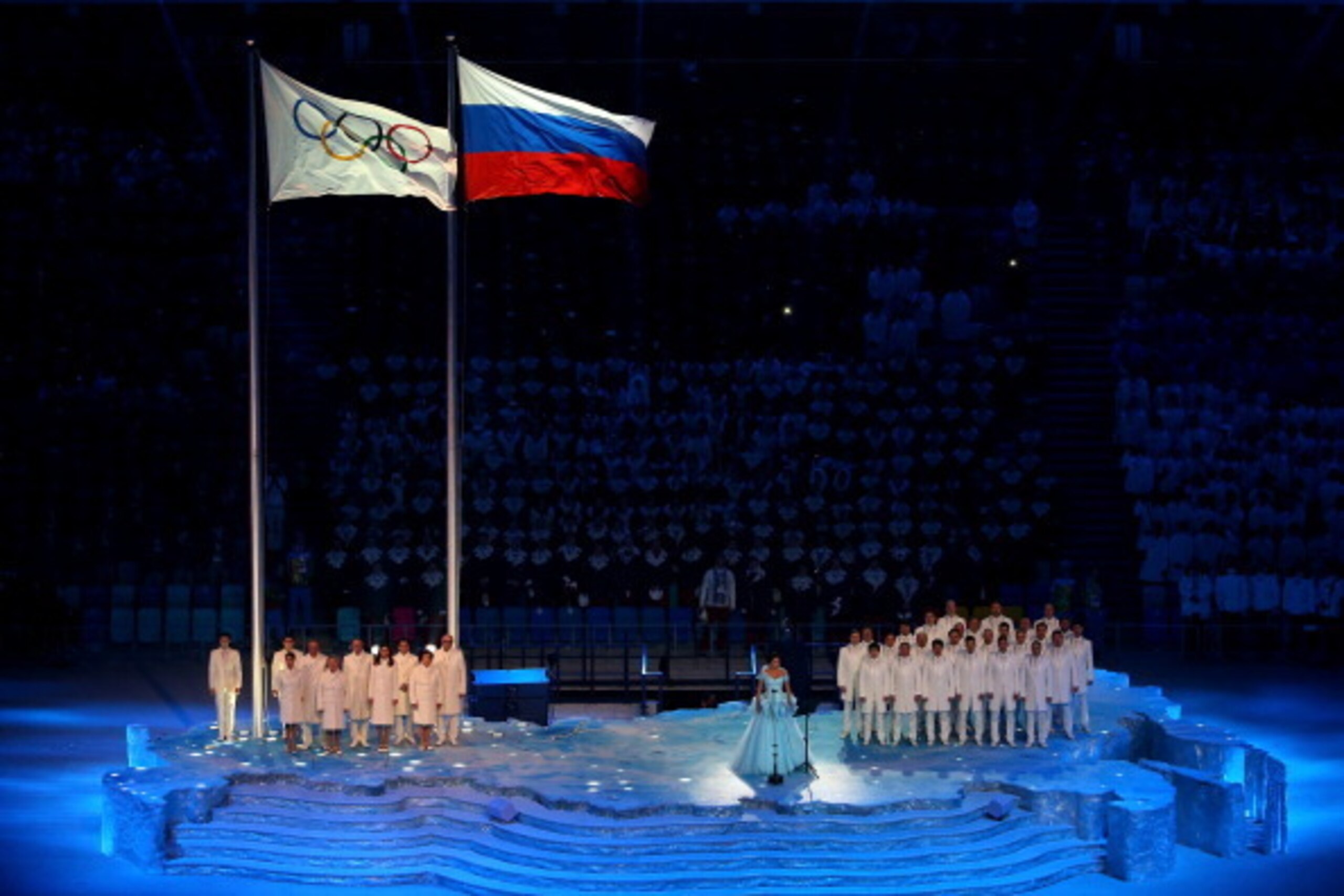 SOCHI, RUSSIA - FEBRUARY 07:  Soprano Anna Netrebko sings as the Olympic flag is raised during the Opening Ceremony of the Sochi 2014 Winter Olympics at Fisht Olympic Stadium on February 7, 2014 in Sochi, Russia.  (Photo by Quinn Rooney/Getty Images)