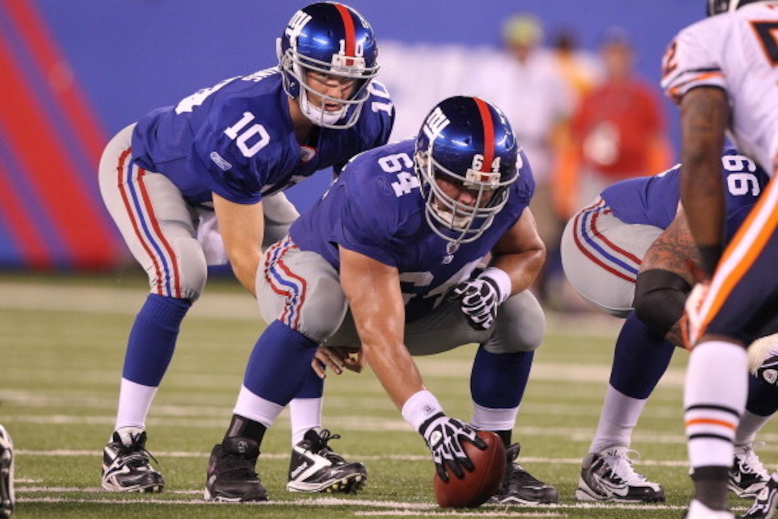 EAST RUTHERFORD, NJ - AUGUST 22:  Eli Manning #10 and David Baas #64 of the New York Giants  in action during their pre season game on August 22, 2011 at The New Meadowlands Stadium in East Rutherford, New Jersey.  (Photo by Al Bello/Getty Images)