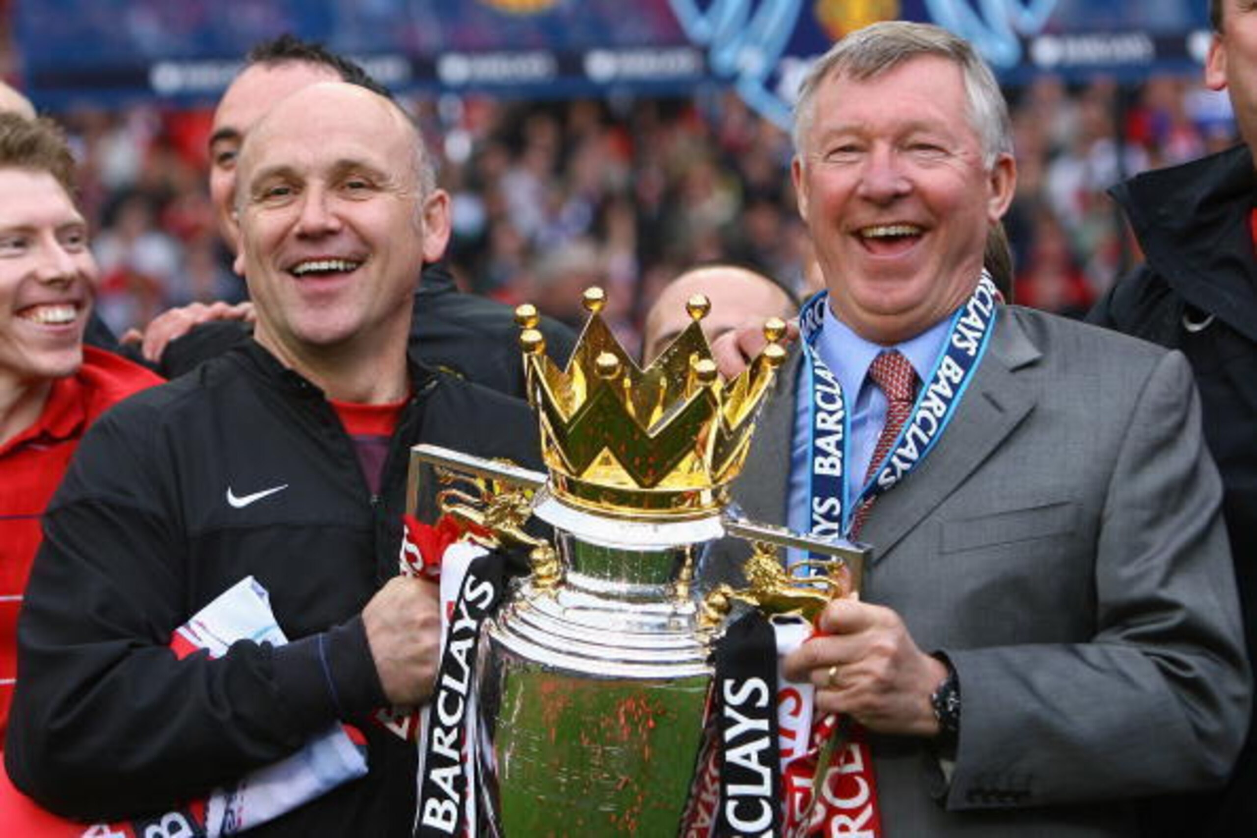 MANCHESTER, ENGLAND - MAY 16:  Manchester United Manager Sir Alex Ferguson (R) and Assistant Mike Phelan celebrate with the Barclays Premier League trophy after their side won the Premier League title at the end of the Barclays Premier League match betwee