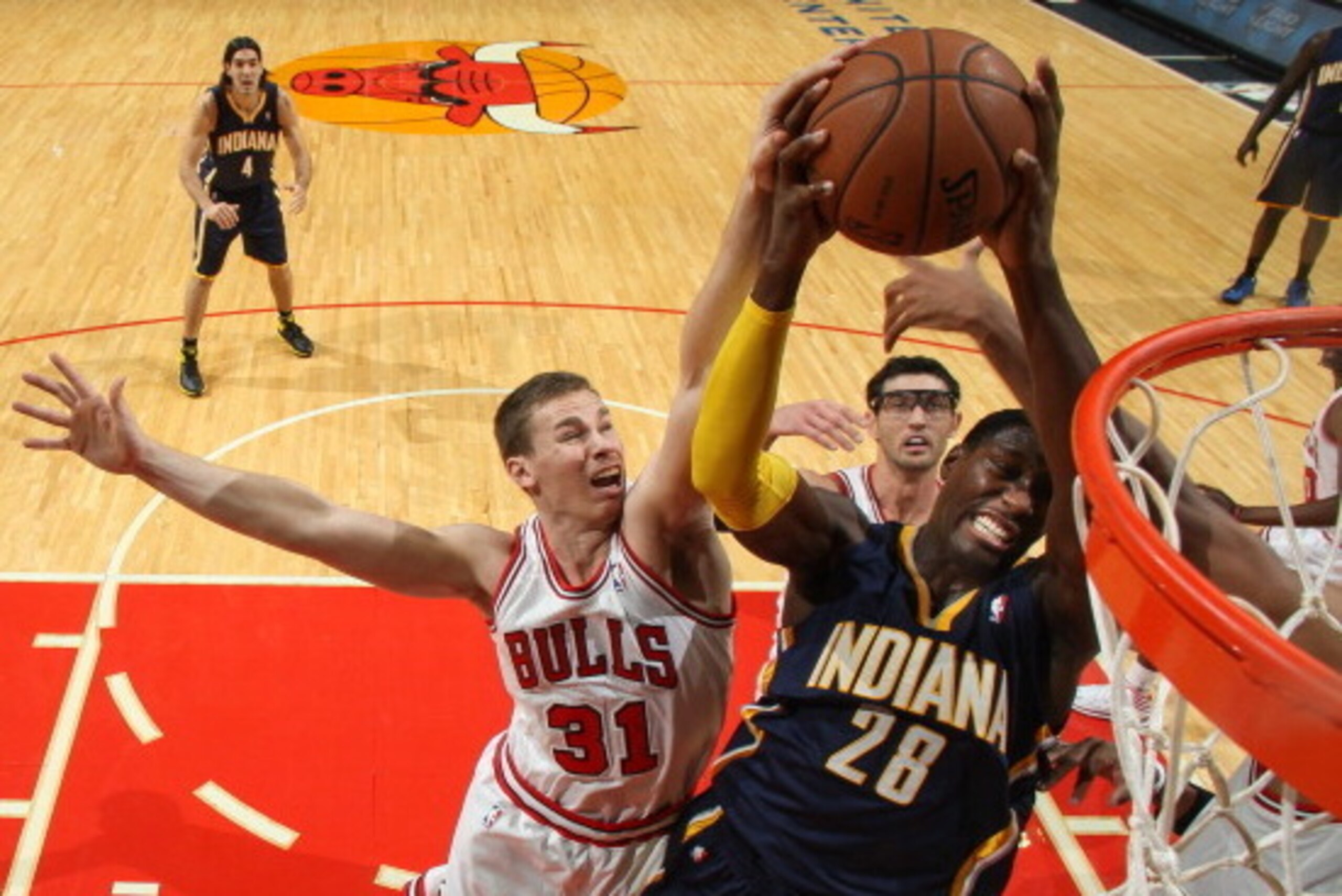 CHICAGO, IL - OCTOBER 18: Erik Murphy #31 of the Chicago Bulls attempts to block a shot against Ian Mahinmi #28 of the Indiana Pacers on October 18, 2013 at the United Center in Chicago, Illinois. NOTE TO USER: User expressly acknowledges and agrees that,