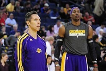 December 22, 2012; Oakland, CA, USA; Los Angeles Lakers point guard Steve Nash (10, left) and center Dwight Howard (12, right) look on during warm ups before the game against the Golden State Warriors at ORACLE Arena. Mandatory Credit: Kyle Terada-USA TOD