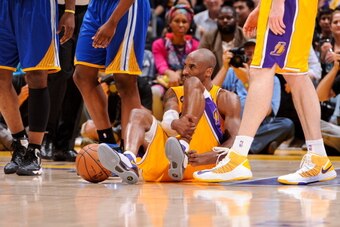 LOS ANGELES, CA - APRIL 12: Kobe Bryant #24 of the Los Angeles Lakers reacts on the floor after getting injured during a game against the Golden State Warriors at Staples Center on April 12, 2013 in Los Angeles, California. NOTE TO USER: User expressly ac