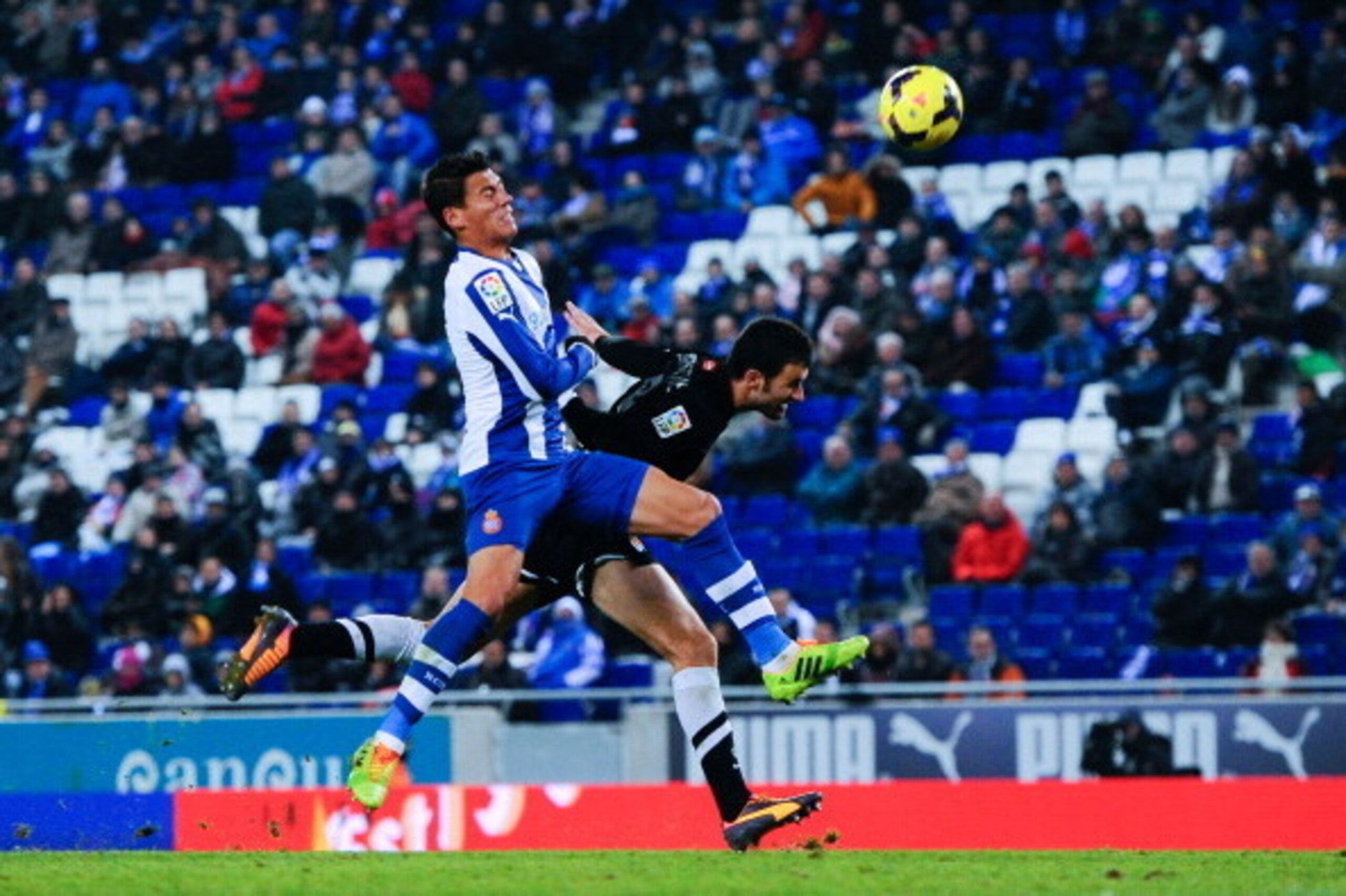 BARCELONA, SPAIN - NOVEMBER 30:  Imanol Agirretxe of Real Sociedad head the ball towards goal under a challenge by Hector Moreno of RCD Espanyol during the La Liga match between RCD Espanyol and Real Sociedad de Futbol at Cornella-El Prat Stadium on Novem