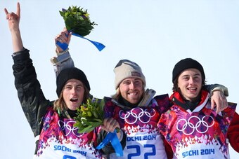SOCHI, RUSSIA - FEBRUARY 08:  (L-R) Silver medalist Staale Sandbech of Norway, gold medalist Sage Kotsenburg of the United States and bronze medalist Mark McMorris of Canada pose on the podium during the flower ceremony following the Snowboard Men's Slope