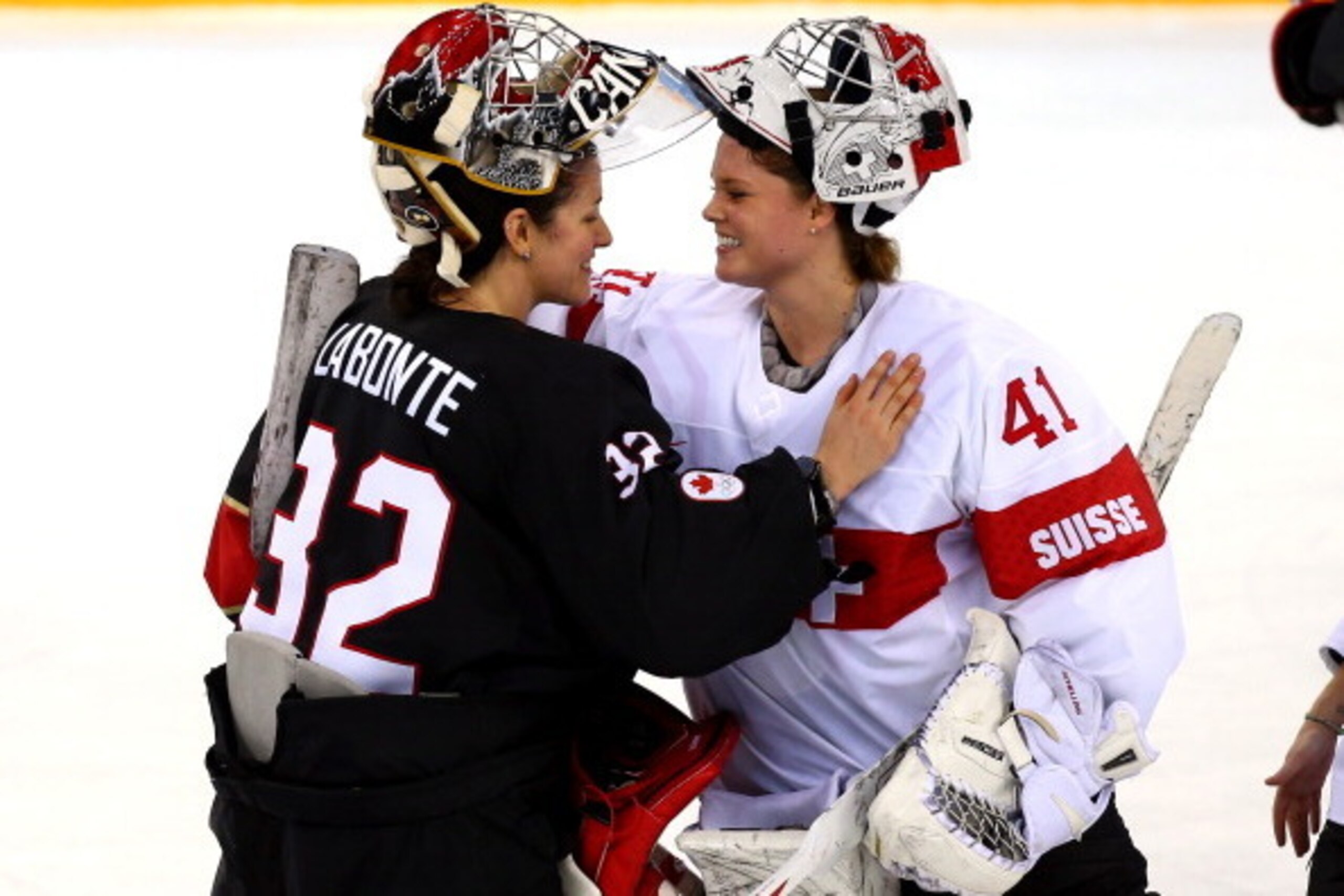 SOCHI, RUSSIA - FEBRUARY 08:  Charline Labonte #32 of Canada talks with Florence Schelling #41 of Switzerland after winning 5 to 0 in their Women's Ice Hockey Preliminary Round Group A Game on day 1 of the Sochi 2014 Winter Olympics at Shayba Arena on Feb