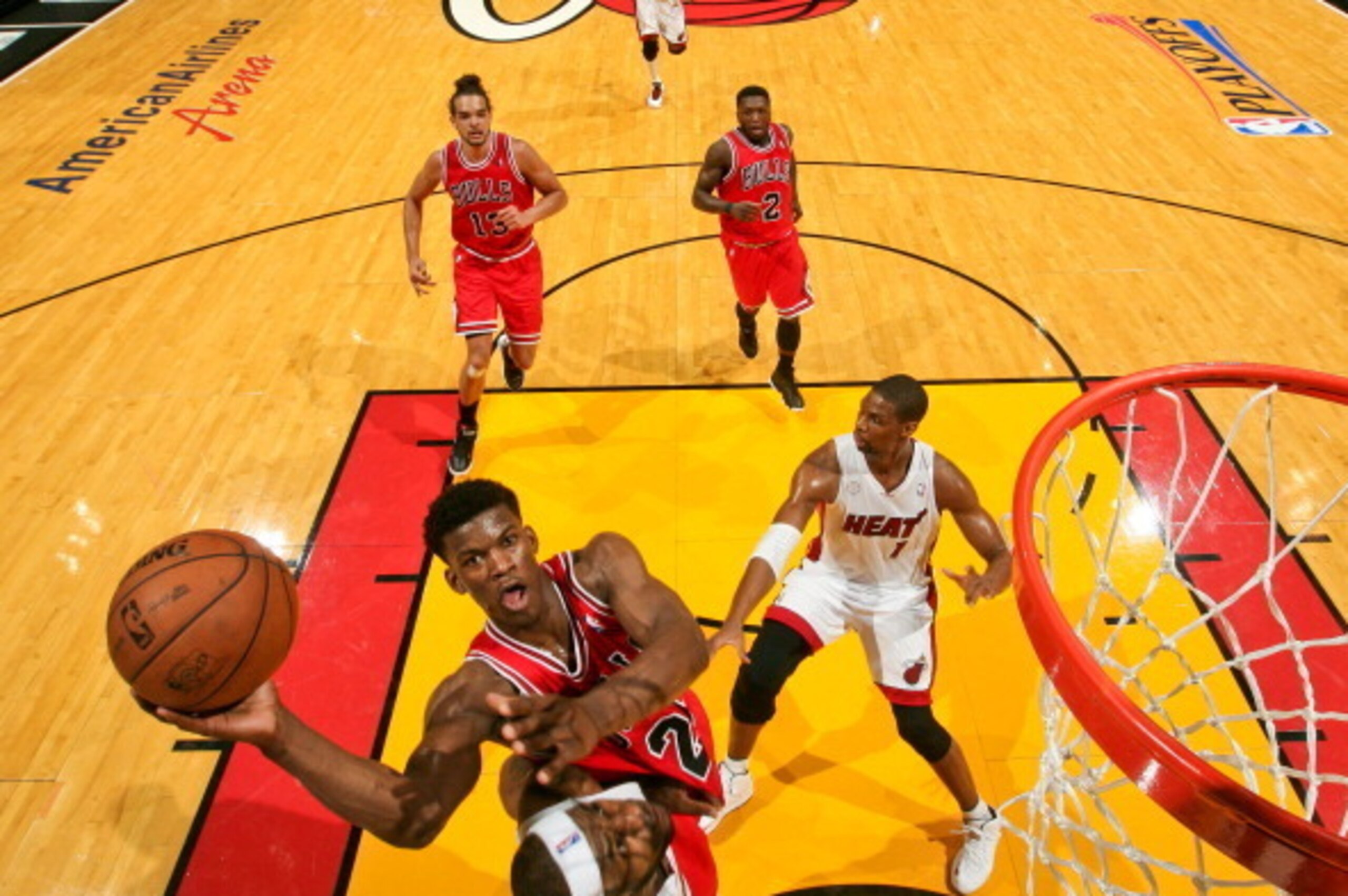 MIAMI, FL - MAY 15: Jimmy Butler #21 of the Chicago Bulls drives to the basket against LeBron James #6 of the Miami Heat in Game Five of the Eastern Conference Semifinals during the 2013 NBA Playoffs on May 15, 2013 at American Airlines Arena in Miami, Fl