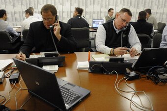 Reggie McKenzie and John Dorsey working the phones on draft day.