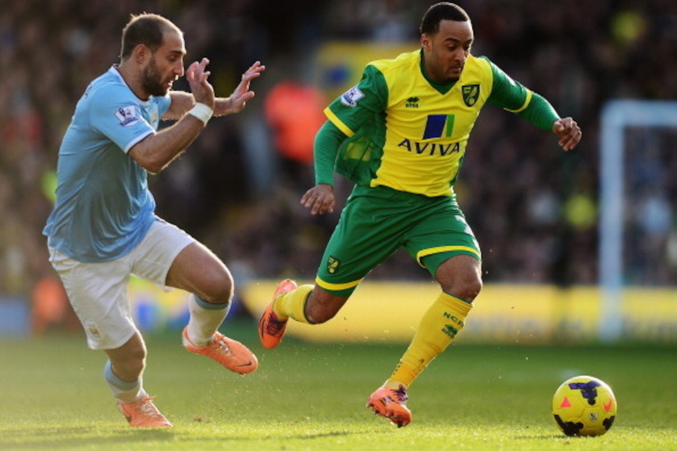 NORWICH, ENGLAND - FEBRUARY 08: Nathan Redmond (R) of Norwich City holds off the challenge of Pablo Zabaleta (L) of Manchester City during the Barclays Premier League match between Norwich City and Manchester City at Carrow Road on February 8, 2014 in No NORWICH, ENGLAND - FEBRUARY 08: Nathan Redmond (R) of Norwich City holds off the challenge of Pablo Zabaleta (L) of Manchester City during the Barclays Premier League match between Norwich City and Manchester City at Carrow Road on February 8, 2014 in No