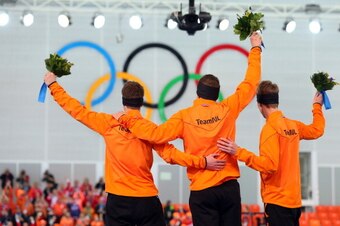 SOCHI, RUSSIA - FEBRUARY 08:  (L-R) Silver medalist Jan Blokhuijsen of the Netherlands, gold medalist Sven Kramer of the Netherlands and bronze medalist Jorrit Bergsma of the Netherlands on the podium during the flower ceremony for the Men's 5000m Speed S