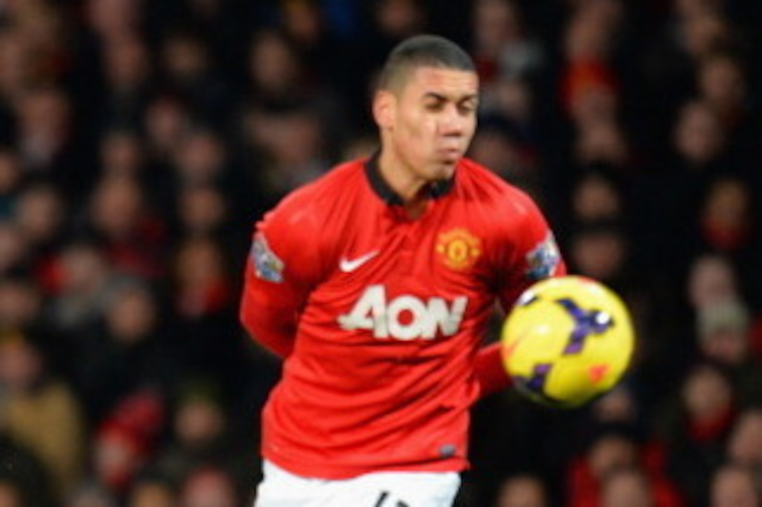 MANCHESTER, ENGLAND - JANUARY 11:  Alejandro Pozuelo of Swansea City shoots past Chris Smalling of Manchester United during the Barclays Premier League match between Manchester United and Swansea City at Old Trafford on January 11, 2014 in Manchester, Eng