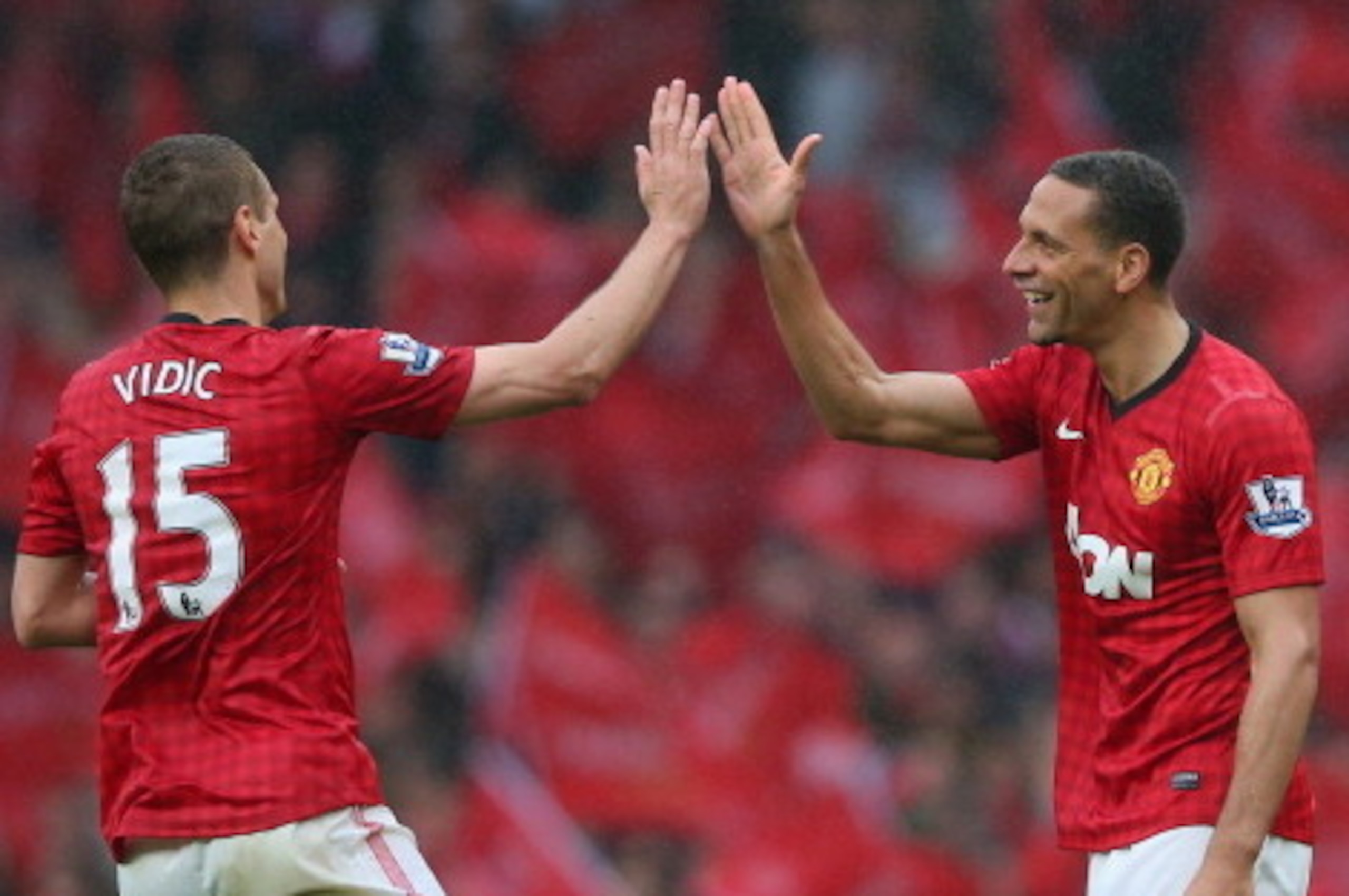 MANCHESTER, ENGLAND - MAY 12:  Rio Ferdinand of Manchester United celebrates scoring the winning goal with team-mate Nemanja Vidic during the Barclays Premier League match between Manchester United and Swansea City at Old Trafford on May 12, 2013 in Manch