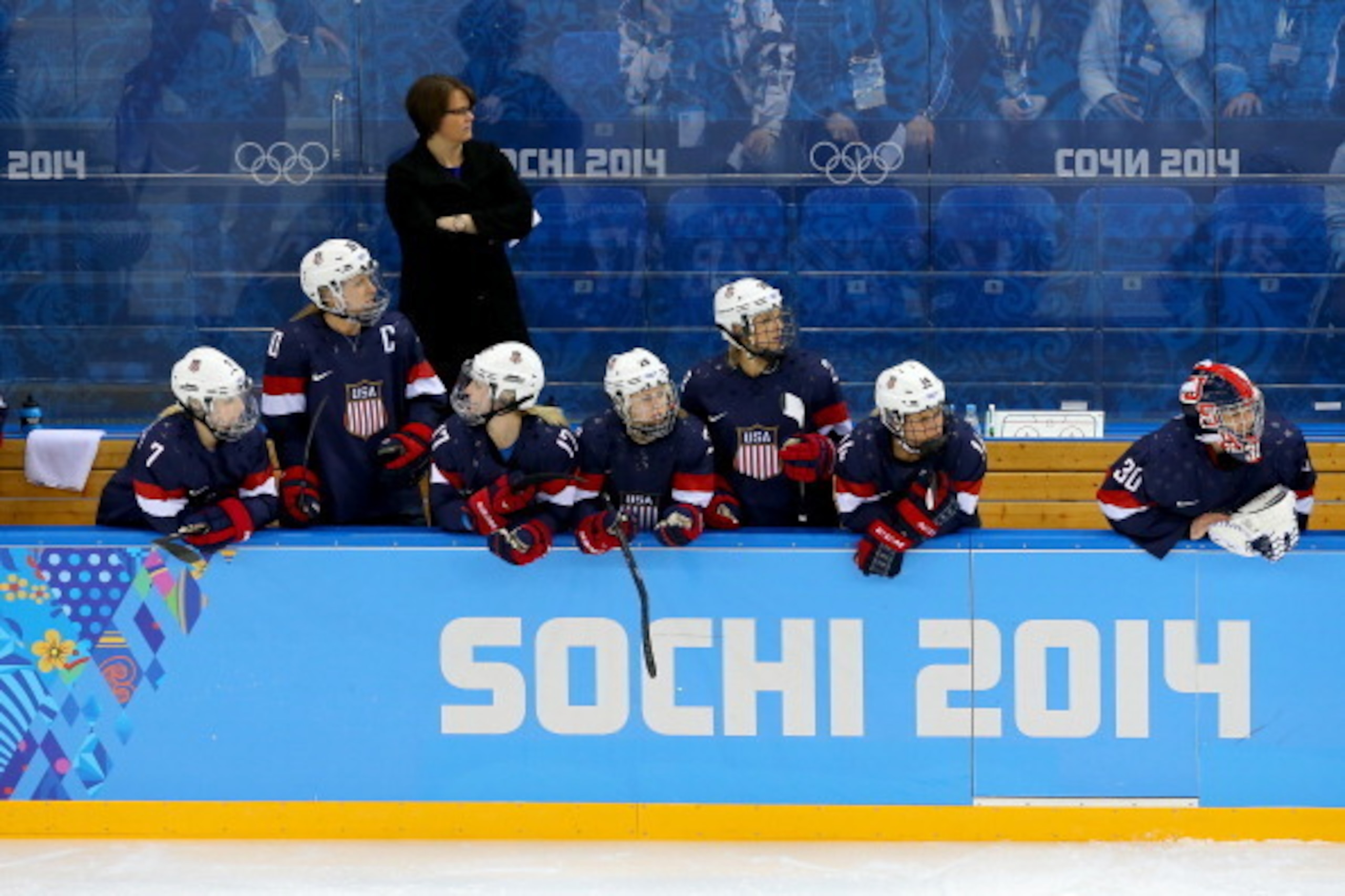 SOCHI, RUSSIA - FEBRUARY 08: Head coach Katey Stone of the United States looks on from the bench during the Women's Ice Hockey Preliminary Round Group A Game against Finland on day 1 of the Sochi 2014 Winter Olympics at Shayba Arena on February 8, 2014 i SOCHI, RUSSIA - FEBRUARY 08: Head coach Katey Stone of the United States looks on from the bench during the Women's Ice Hockey Preliminary Round Group A Game against Finland on day 1 of the Sochi 2014 Winter Olympics at Shayba Arena on February 8, 2014 i