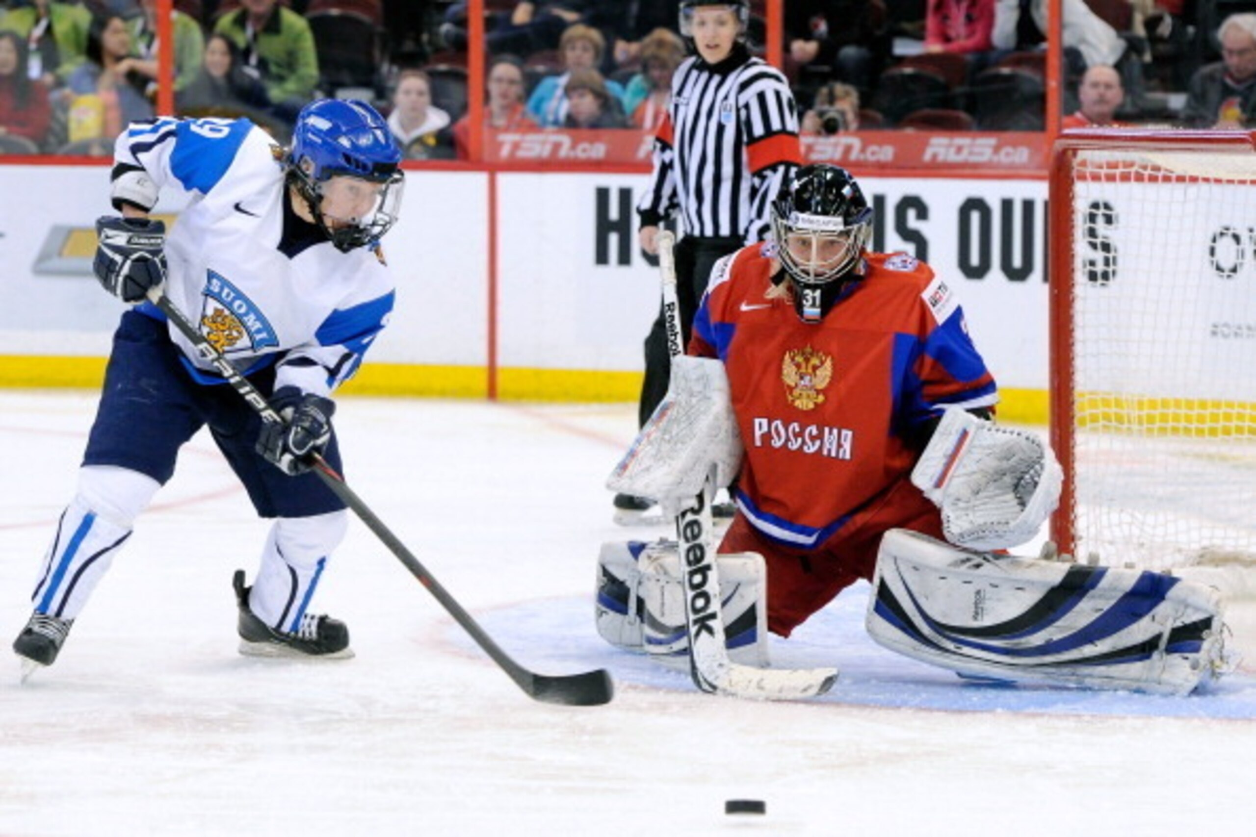 OTTAWA, CANADA - APRIL 9:  Nadezhda Alexandrova #31 of Team Russia stops the puck in front of Karoliina Rantamaki #29 of Team Finland during the IIHF Womens World Championship Bronze Medal Game at Scotiabank Place on April 9, 2013 in Ottawa, Ontario, Cana