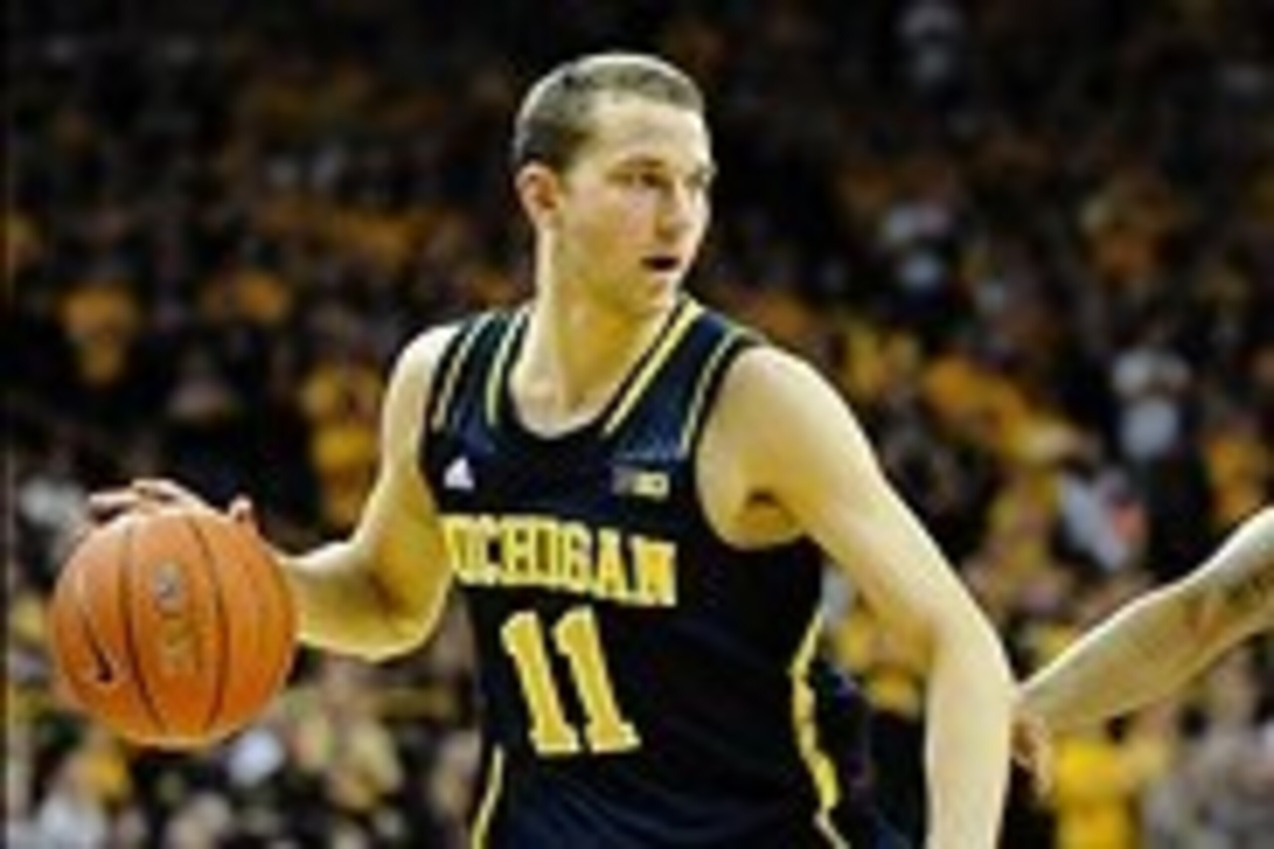 Feb 8, 2014; Iowa City, IA, USA; Michigan Wolverine guard Nik Stauskas (11) dribbles around Iowa Hawkeyes guard Roy Devyn Marble (4) at Carver-Hawkeye Arena. Mandatory Credit: Steven Branscombe-USA TODAY Sports