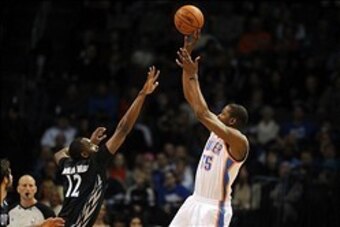 Feb 5, 2014; Oklahoma City, OK, USA; Oklahoma City Thunder small forward Kevin Durant (35) shoots the ball over Minnesota Timberwolves power forward Luc Richard Mbah a Moute (12) during the second quarter at Chesapeake Energy Arena. Mandatory Credit: Mark