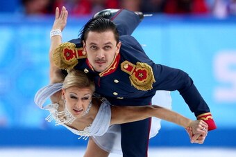 SOCHI, RUSSIA - FEBRUARY 06:  Tatiana Volosozhar and Maxim Trankov of Russia compete in the Figure Skating Pairs Short Program during the Sochi 2014 Winter Olympics at Iceberg Skating Palace on February 6, 2014 in Sochi, Russia.  (Photo by Clive Mason/Get