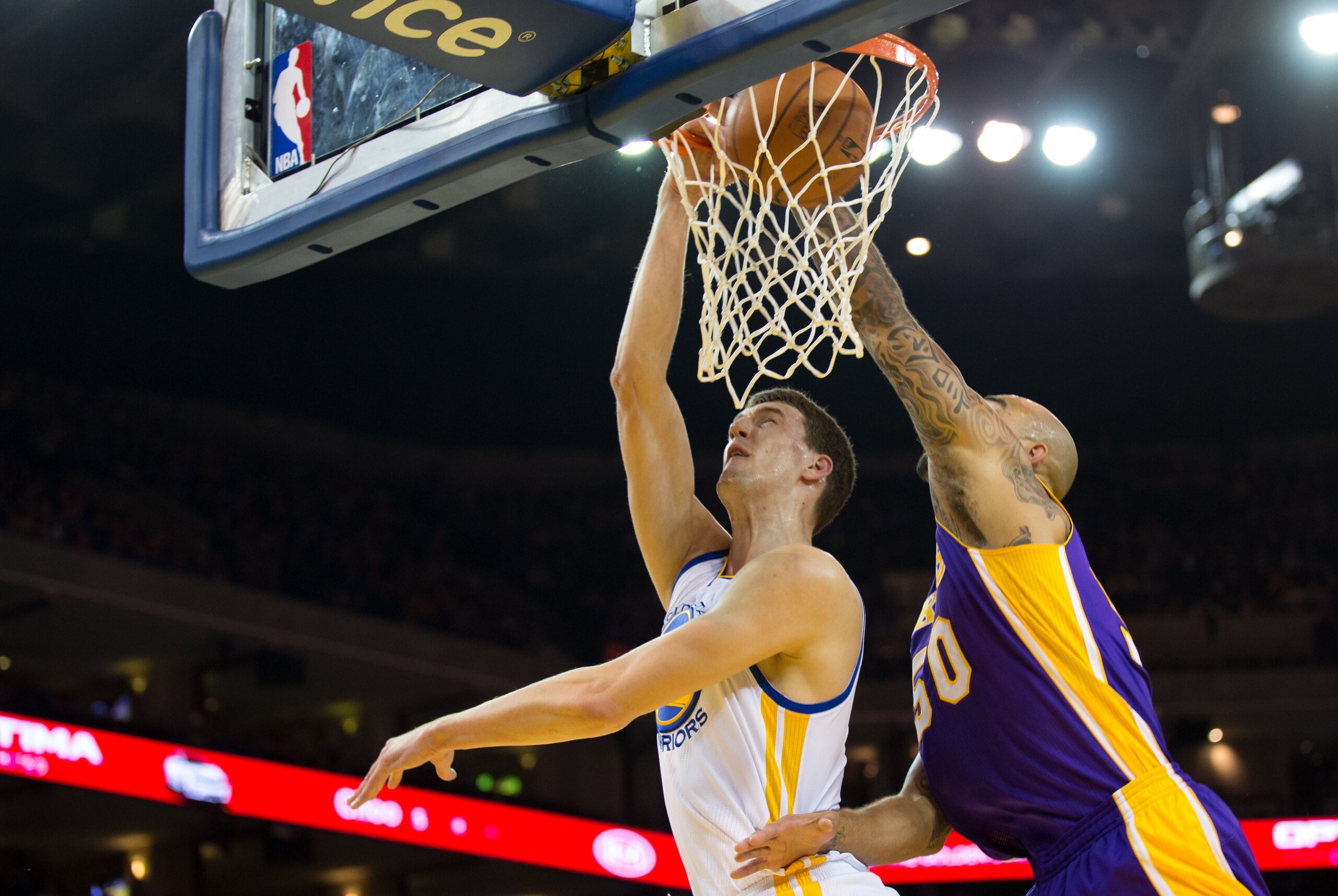 Oct 30, 2013; Oakland, CA, USA; Golden State Warriors center Ognjen Kuzmic (1) scores a basket against Los Angeles Lakers center Robert Sacre (50) during the fourth quarter at Oracle Arena. The Golden State Warriors defeated the Los Angeles Lakers 125-94.