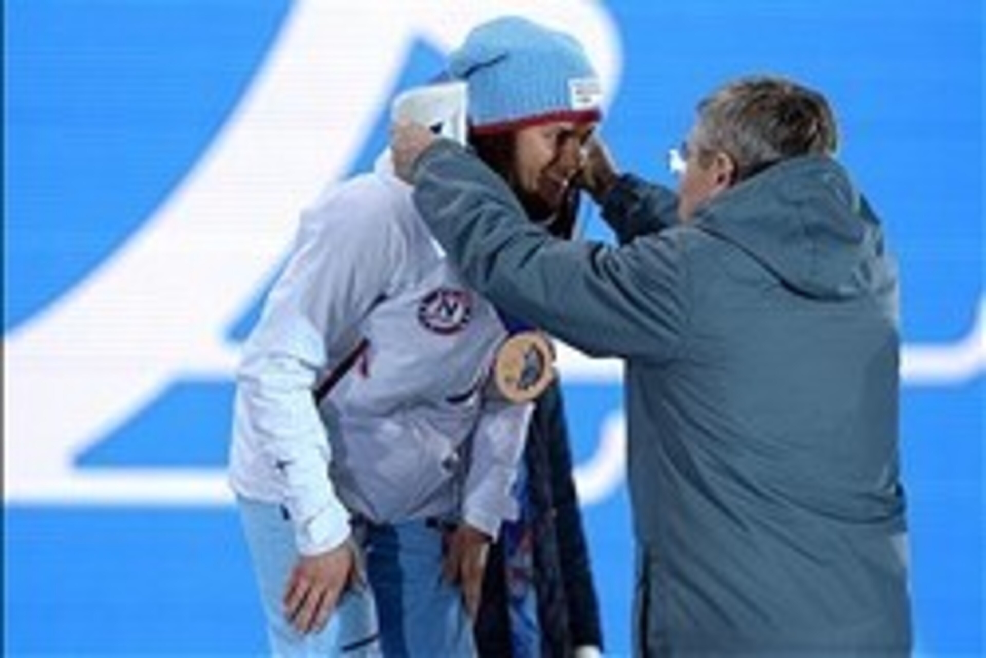 Feb 8, 2014; Sochi, RUSSIA; Heidi Weng (NOR) receives her bronze medal from IOC president Thomas Bach during the medal ceremony for the ladies' 7.5km + 7.5km skiathlon in the Sochi 2014 Olympic Winter Games at the Medals Plaza. Mandatory Credit: Kyle Tera