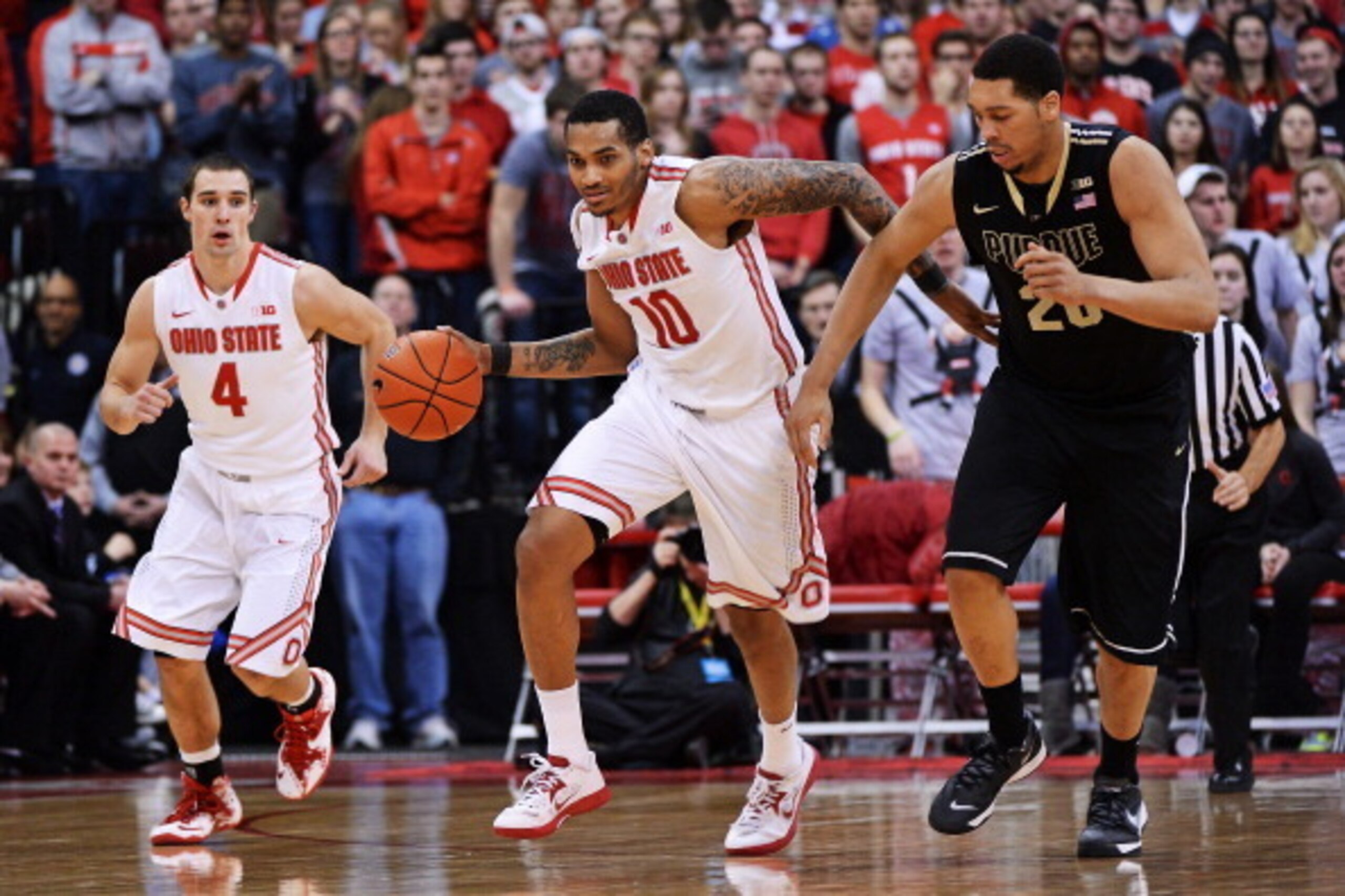 COLUMBUS, OH - FEBRUARY 8:  LaQuinton Ross #10 of the Ohio State Buckeyes brings the ball up court after a turnover in the second half as A.J. Hammons #20 of the Purdue Boilermakers and Aaron Craft #4 of the Ohio State Buckeyes follow on February 8, 2014 