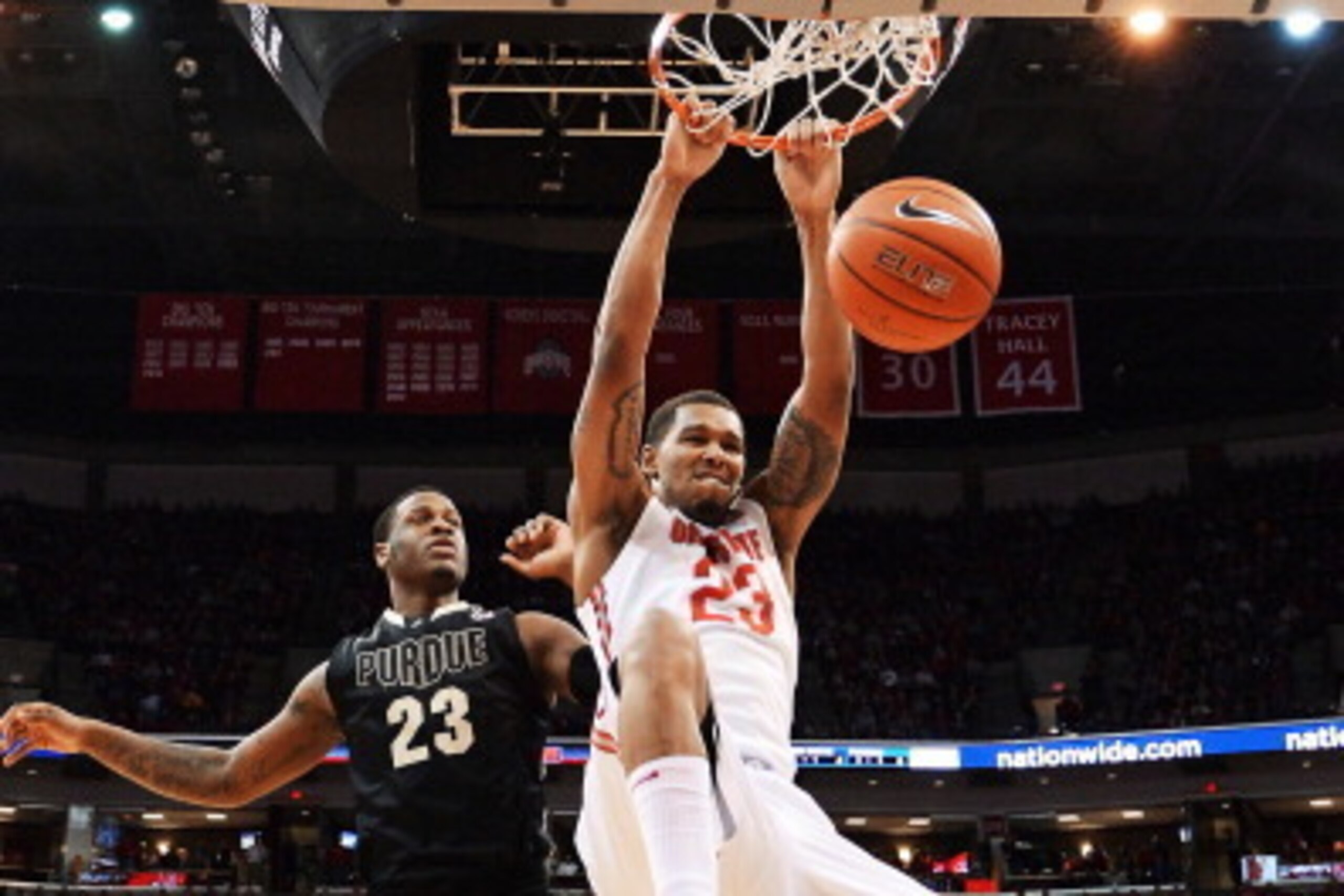 COLUMBUS, OH - FEBRUARY 8:  Amir Williams #23 of the Ohio State Buckeyes slams home two points in the first half over Jay Simpson #23 of the Purdue Boilermakers on February 8, 2014 at Value City Arena in Columbus, Ohio. Ohio State defeated Purdue 67-49.  