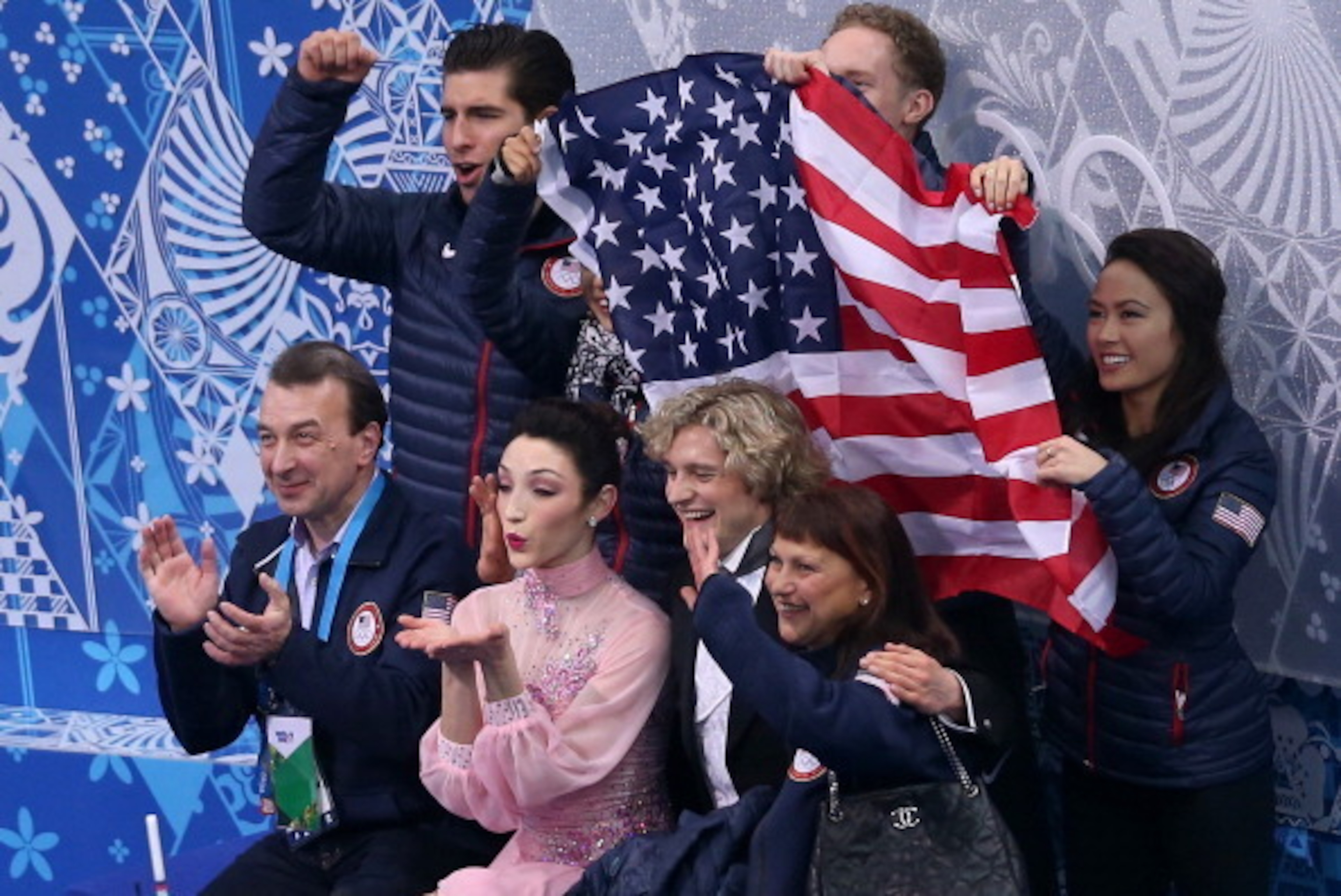 SOCHI, RUSSIA - FEBRUARY 08:  Meryl Davis and Charlie White of the United States wait for their score with teammates and coaches during the Figure Skating Team Ice Dance - Short Dance during day one of the Sochi 2014 Winter Olympics at Iceberg Skating Pal