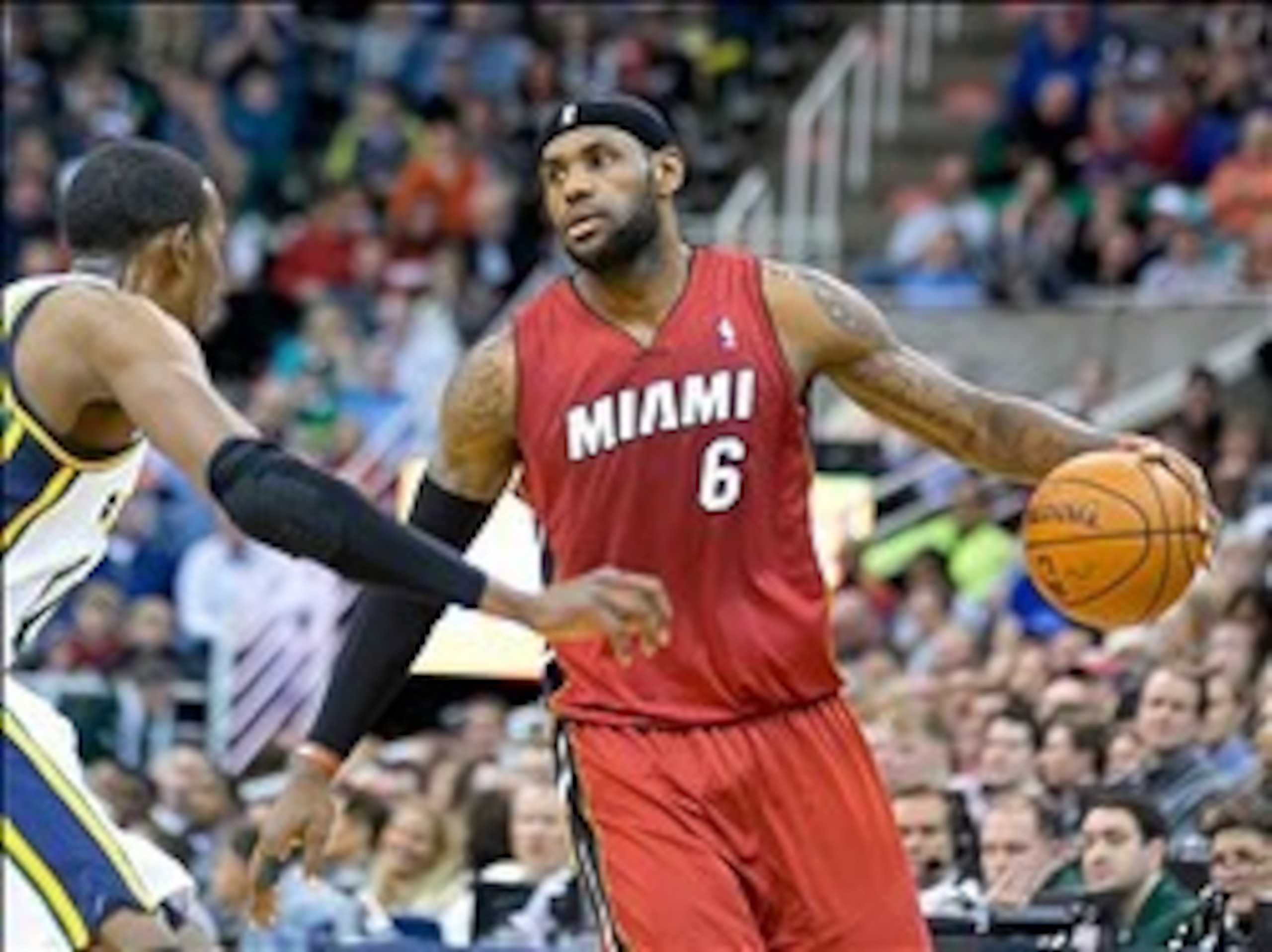 Feb 8, 2014; Salt Lake City, UT, USA; Miami Heat small forward LeBron James (6) controls the ball while defended by Utah Jazz small forward Jeremy Evans (40) during the first half at EnergySolutions Arena. Mandatory Credit: Russ Isabella-USA TODAY Sports