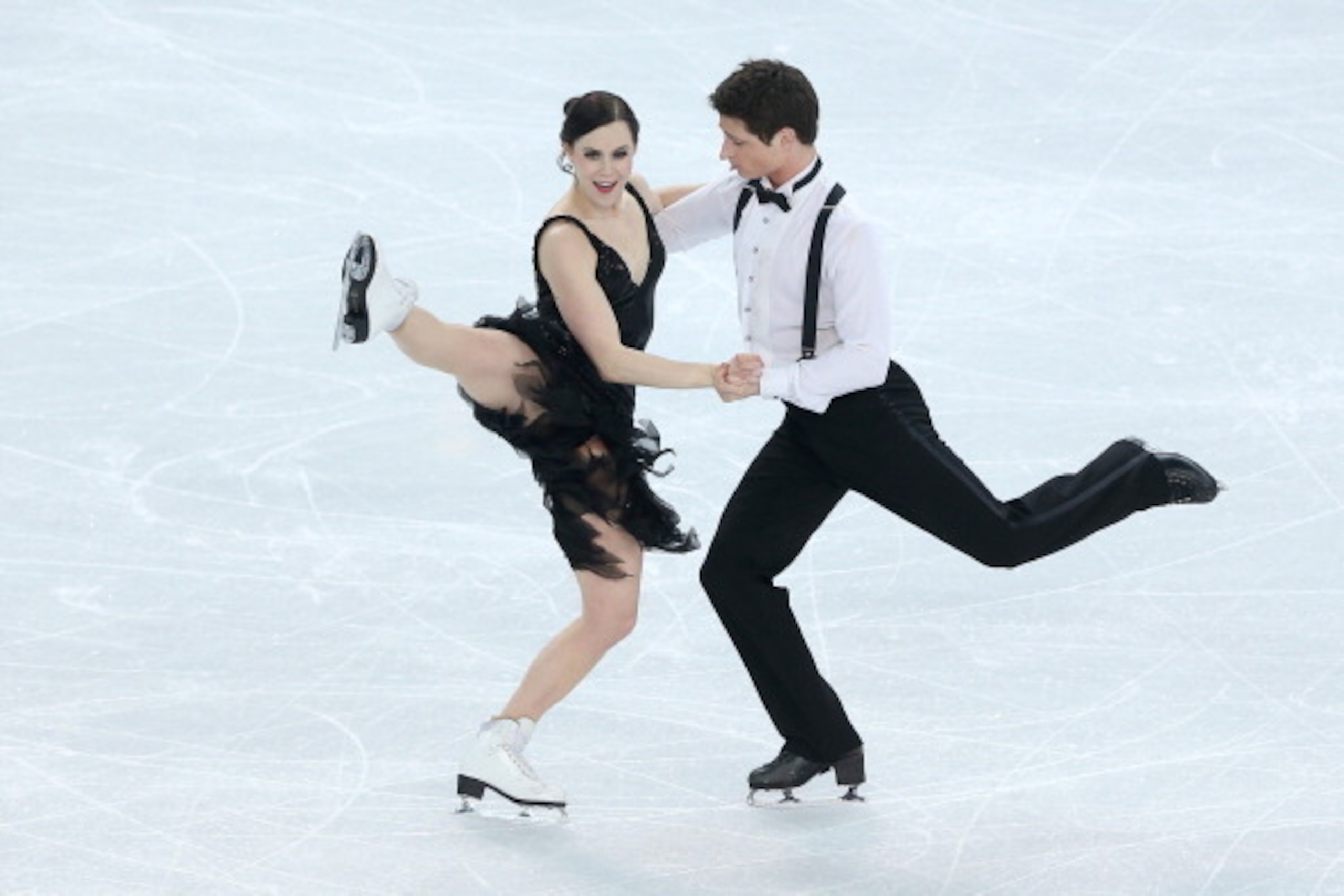 SOCHI, RUSSIA - FEBRUARY 08:  Tessa Virtue and Scott Moir of Canada compete in the Figure Skating Team Ice Dance - Short Dance during day one of the Sochi 2014 Winter Olympics at Iceberg Skating Palace on February 8, 2014 in Sochi, Russia.  (Photo by Matt