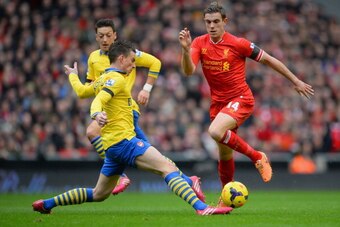 LIVERPOOL, ENGLAND - FEBRUARY 08:  Jordan Henderson of Liverpool is challenged by Laurent Koscielny of Arsenal during the Barclays Premier League match between Liverpool and Arsenal at Anfield on February 8, 2014 in Liverpool, England.  (Photo by Michael 
