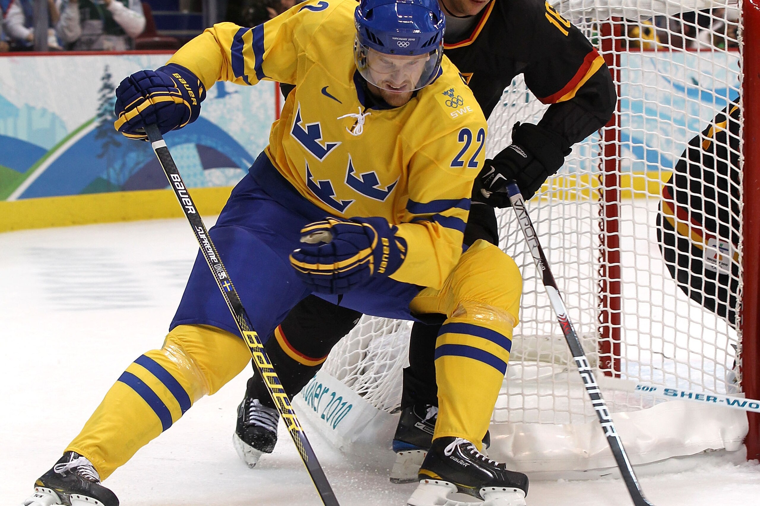 VANCOUVER, BC - FEBRUARY 17: Daniel Sedin of Sweden moves the puck ahead of Kai Hospelt of Germany in the first period during the ice hockey men's preliminary game on day 6 of the Vancouver 2010 Winter Olympics at Canada Hockey Place on February 17, 2010 VANCOUVER, BC - FEBRUARY 17: Daniel Sedin of Sweden moves the puck ahead of Kai Hospelt of Germany in the first period during the ice hockey men's preliminary game on day 6 of the Vancouver 2010 Winter Olympics at Canada Hockey Place on February 17, 2010