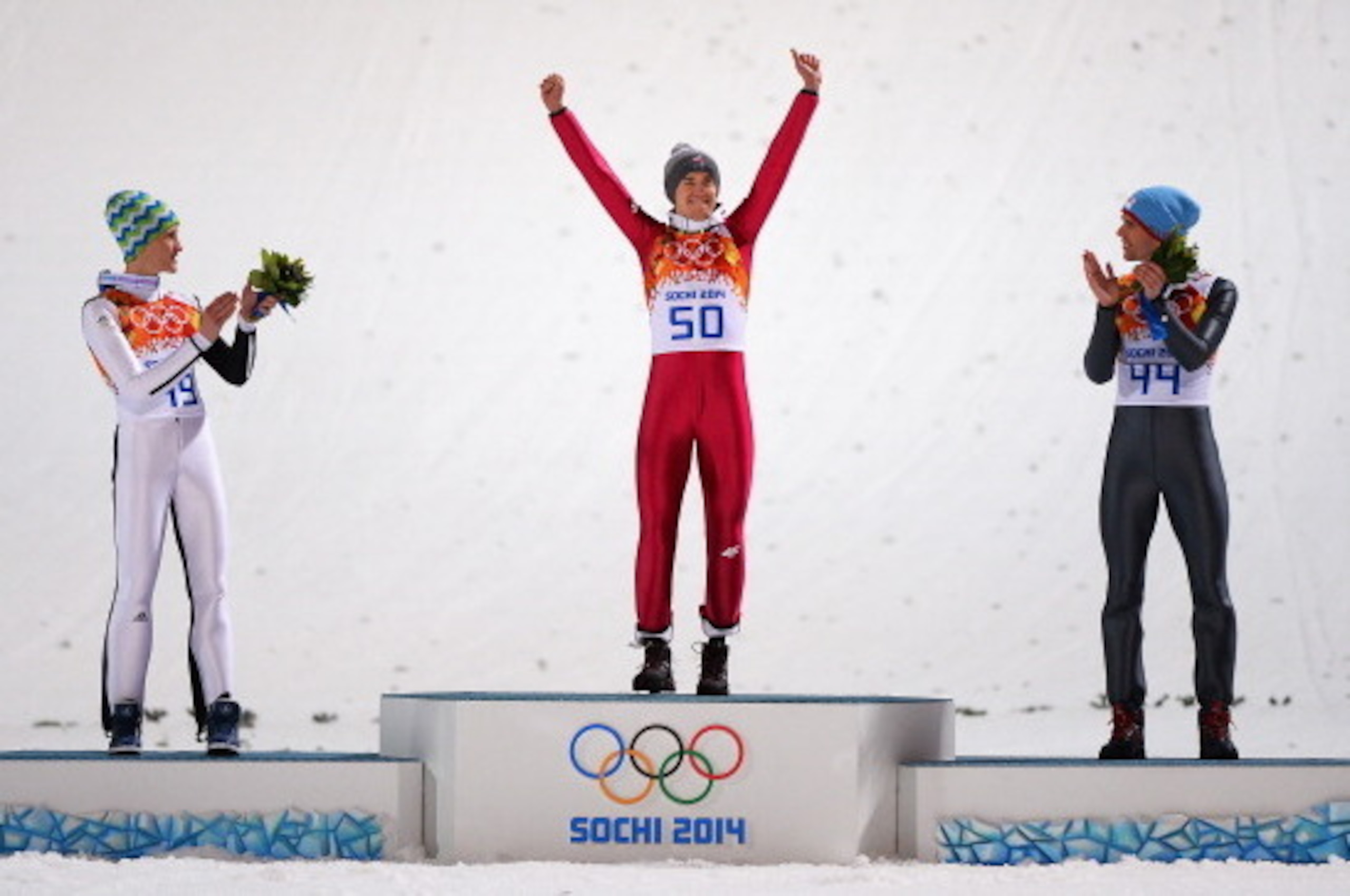 SOCHI, RUSSIA - FEBRUARY 09:  (L-R) Silver medalist Peter Prevc of Slovenia, gold medalist Kamil Stoch of Poland and bronze medalist Anders Bardal of Norway celebrate on the podium during the flower ceremony for the Men's Normal Hill Individual Final on d