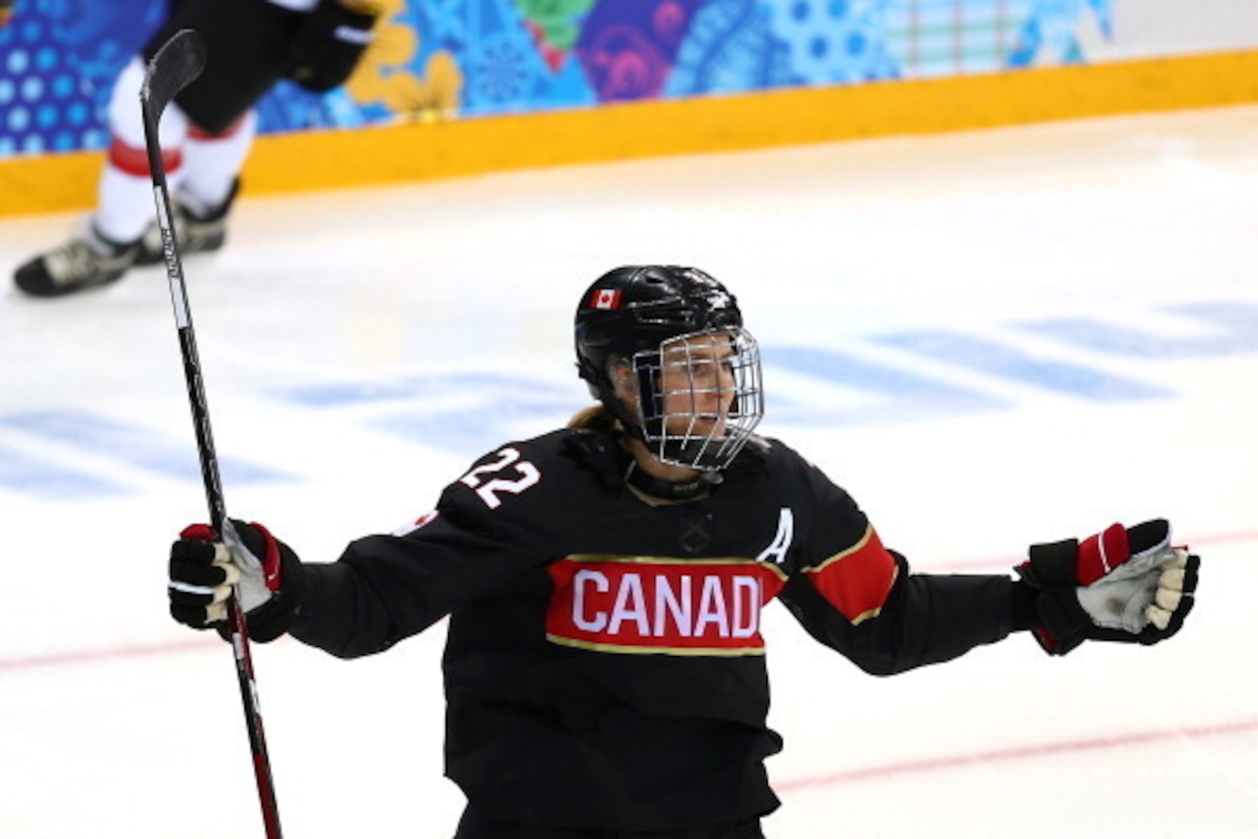 SOCHI, RUSSIA - FEBRUARY 08:  Hayley Wickenheiser #22 of Canada celebrates after scoring a goal against Florence Schelling #41 of Switzerland in the second period during the Women's Ice Hockey Preliminary Round Group A Game on day 1 of the Sochi 2014 Wint