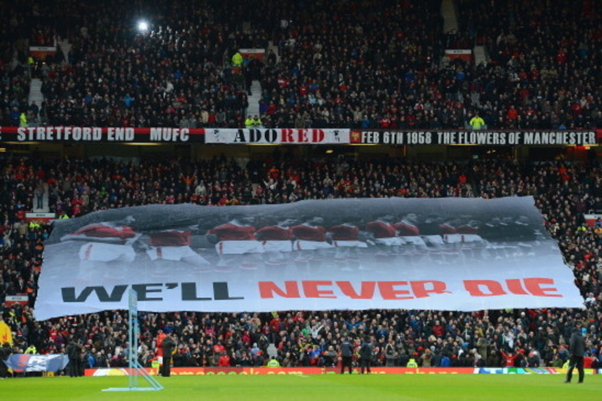 MANCHESTER, ENGLAND - FEBRUARY 10:  A banner is held aloft on the Stretford End honouring the victims of the Munich Air Disaster, following its 55th anniversary on February 6th, prior to the Barclays Premier League match between Manchester United and Ever