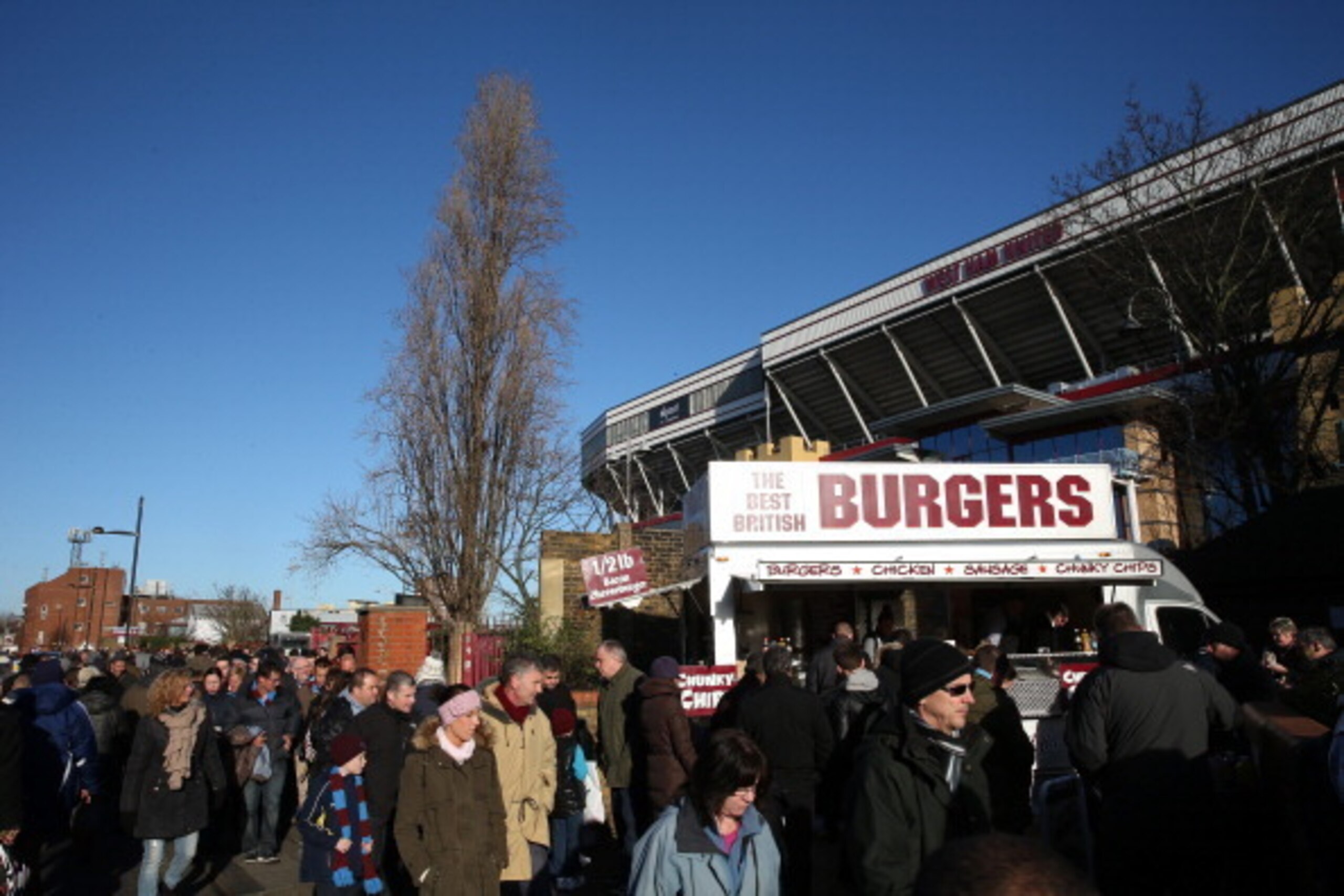 LONDON, ENGLAND - DECEMBER 28: Football fans make their way past a burger stans outside of Upton Park during the Barclays Premier League match between West Ham United and West Bromwich Albion at Boleyn Ground on December 28, 2013 in London, England.  (Pho