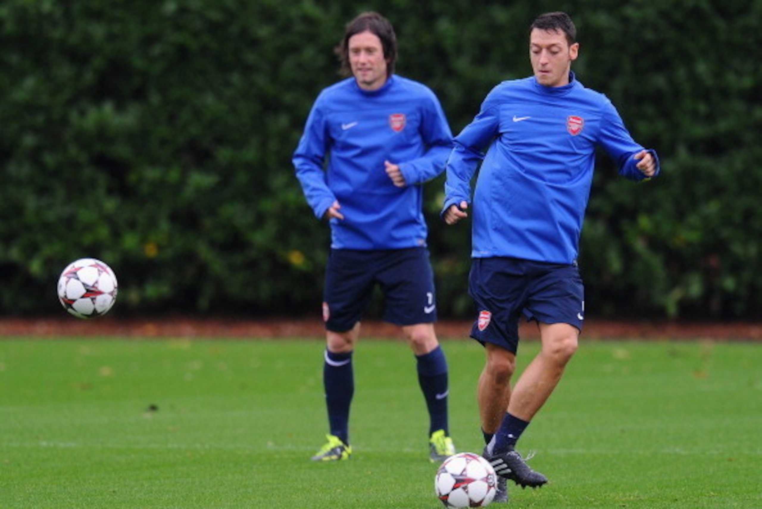 ST ALBANS, ENGLAND - OCTOBER 21: Mesut Oezil (R) and Tomas Rosicky of Arsenal in action during an Arsenal training session ahead of the UEFA Champions League Group F match against Borussia Dortmund at London Colney on October 21, 2013 in St Albans, Engla ST ALBANS, ENGLAND - OCTOBER 21: Mesut Oezil (R) and Tomas Rosicky of Arsenal in action during an Arsenal training session ahead of the UEFA Champions League Group F match against Borussia Dortmund at London Colney on October 21, 2013 in St Albans, Engla