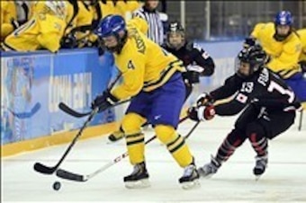 Feb 9, 2014; Sochi, RUSSIA; Sweden forward Jenni Asserholt (4) battles for the puck with Japan forward Moeko Fujimoto (13) in a women's ice hockey preliminary round game during the Sochi 2014 Olympic Winter Games at Shayba Arena. Mandatory Credit: Scott R
