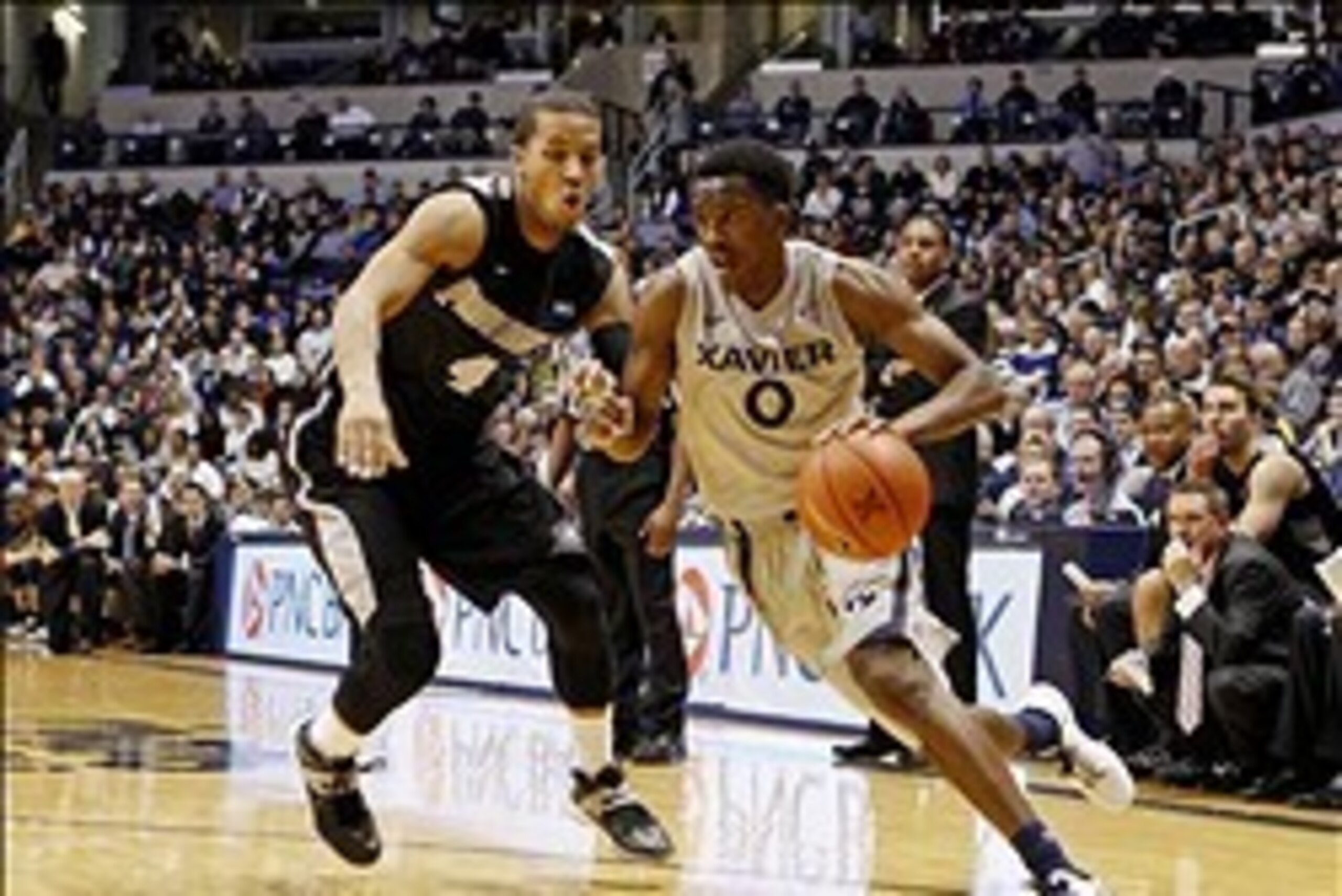 Feb 8, 2014; Cincinnati, OH, USA; Xavier Musketeers guard Semaj Christon (0) drives to the basket during the first half against the Providence Friars guard Josh Fortune (4) at the Cintas Center. Mandatory Credit: Frank Victores-USA TODAY Sports