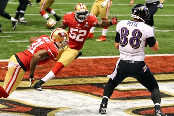 NEW ORLEANS, LA - FEBRUARY 03:  Dennis Pitta #88 of the Baltimore Ravens catches a touchdown pass in front of  Donte Whitner #31 of the San Francisco 49ers and teammate  Patrick Willis in the second quarter during Super Bowl XLVII at the Mercedes-Benz Sup