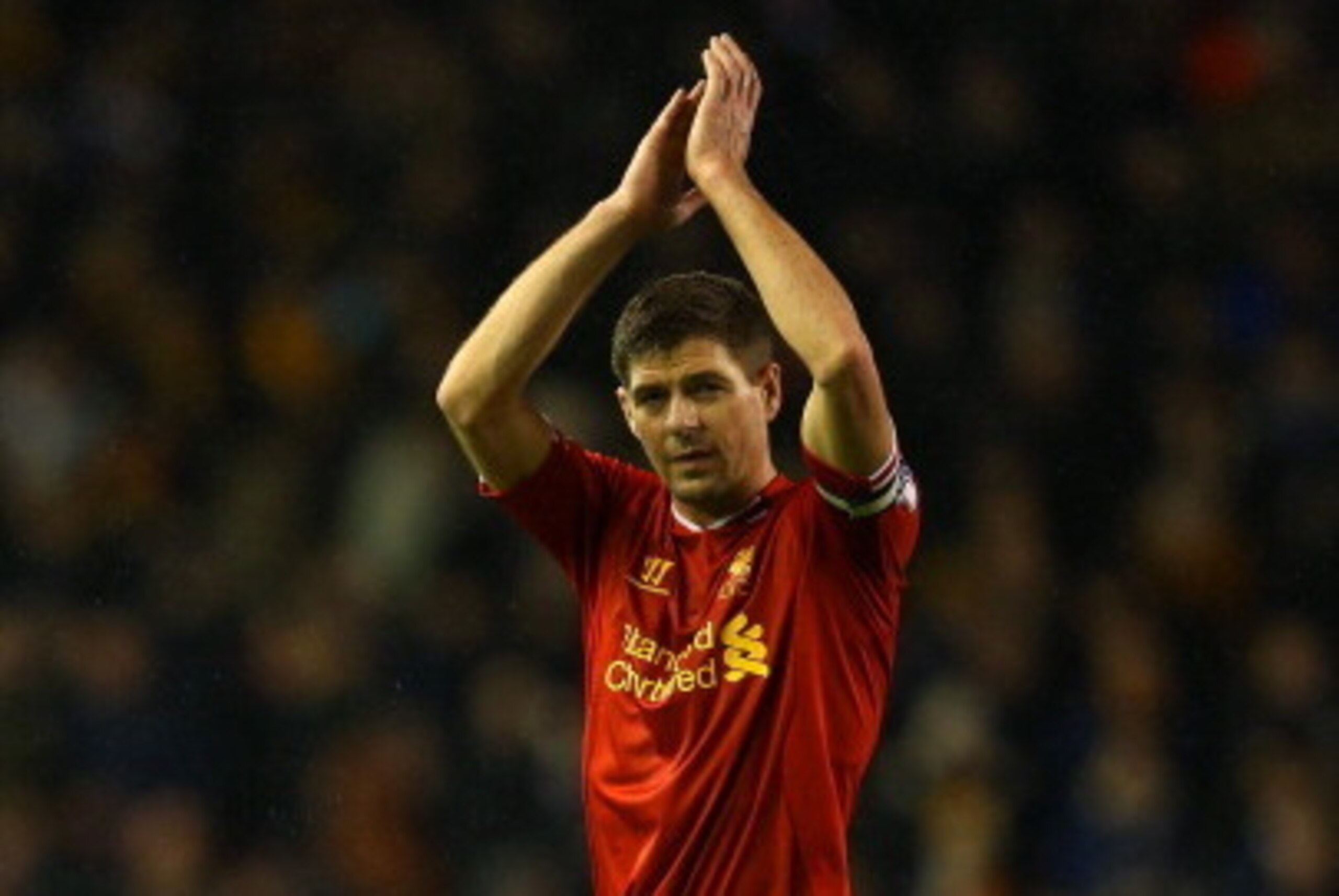 LIVERPOOL, ENGLAND - JANUARY 01: Steven Gerrard of Liverpool applauds the fans at the final whistle  during the Barclays Premier League match between Liverpool and Hull City at Anfield on January 1, 2014 in Liverpool, England.  (Photo by Clive Brunskill/G