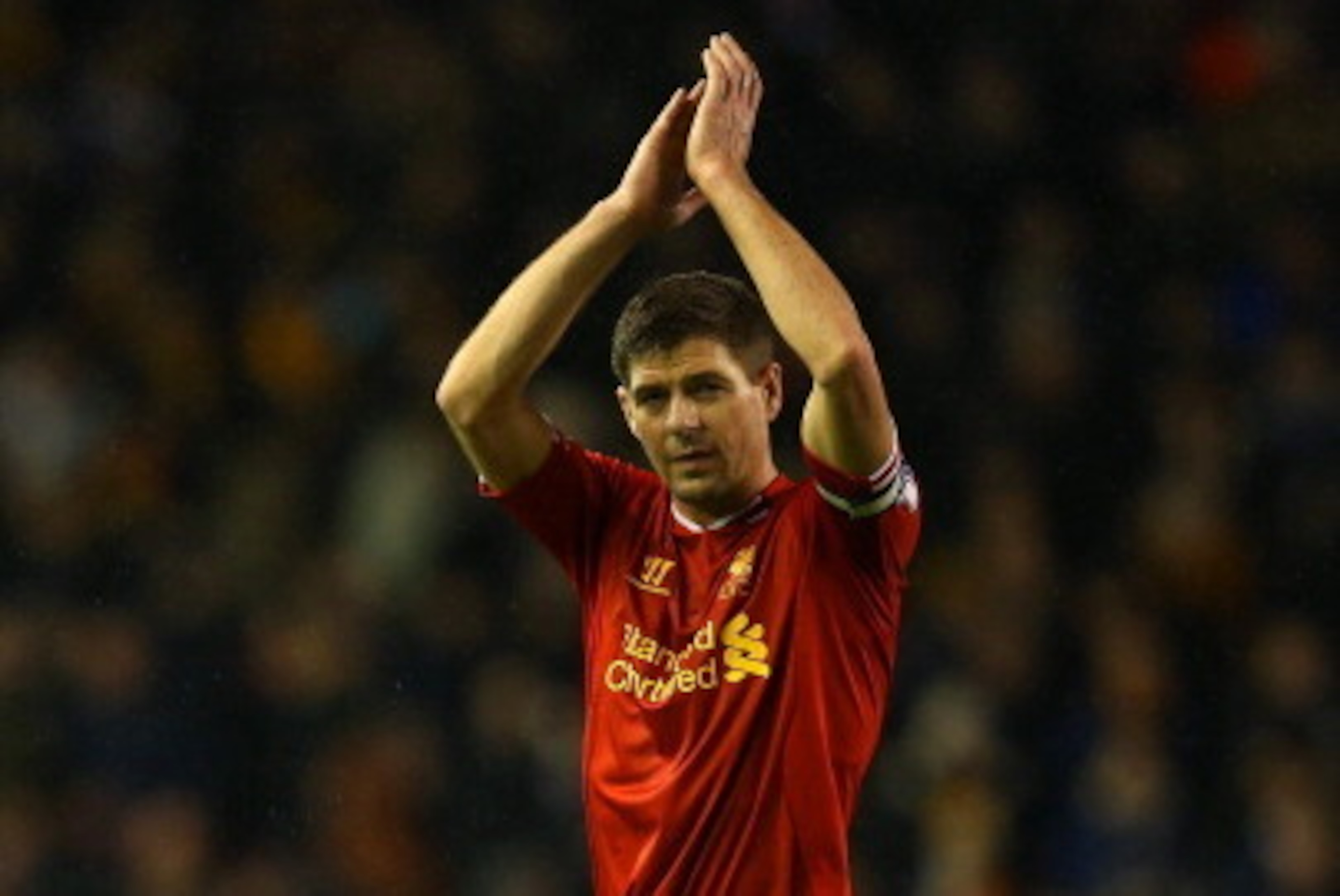 LIVERPOOL, ENGLAND - JANUARY 01: Steven Gerrard of Liverpool applauds the fans at the final whistle  during the Barclays Premier League match between Liverpool and Hull City at Anfield on January 1, 2014 in Liverpool, England.  (Photo by Clive Brunskill/G